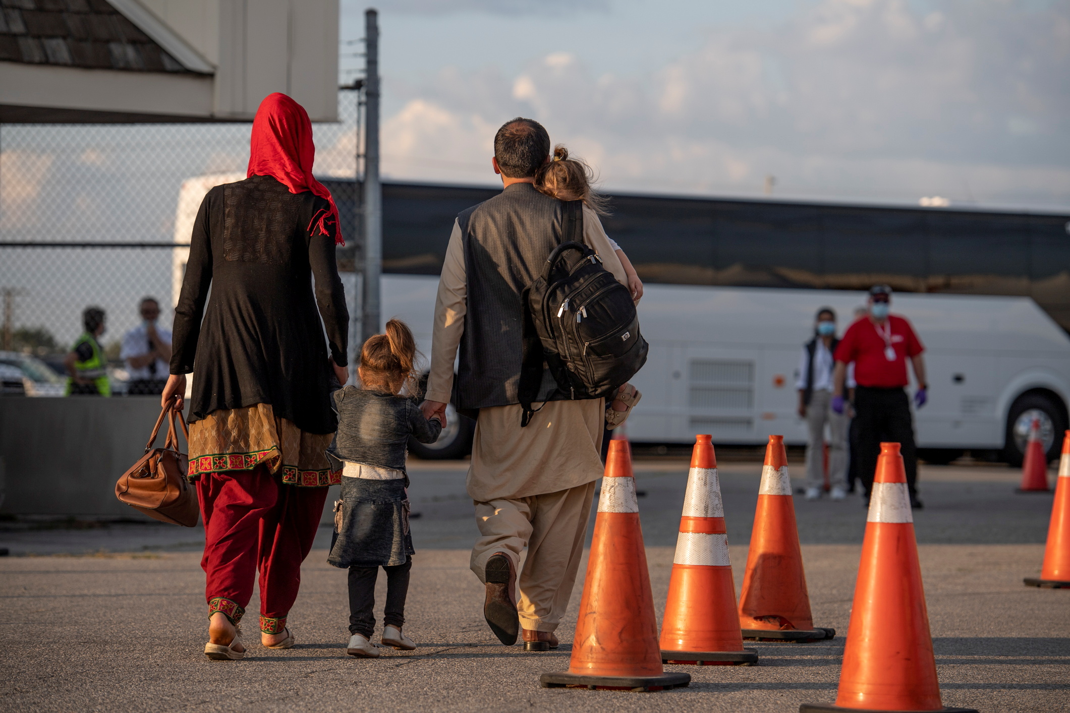 Afghan refugees who supported Canada's mission in Afghanistan prepare to board buses after arriving in Canada, at Toronto Pearson International Airport August 24, 2021. Picture taken August 24, 2021. MCpl Genevieve Lapointe/ Canadian Forces Combat Camera/Canadian Armed Forces Photo/Handout via REUTERS 