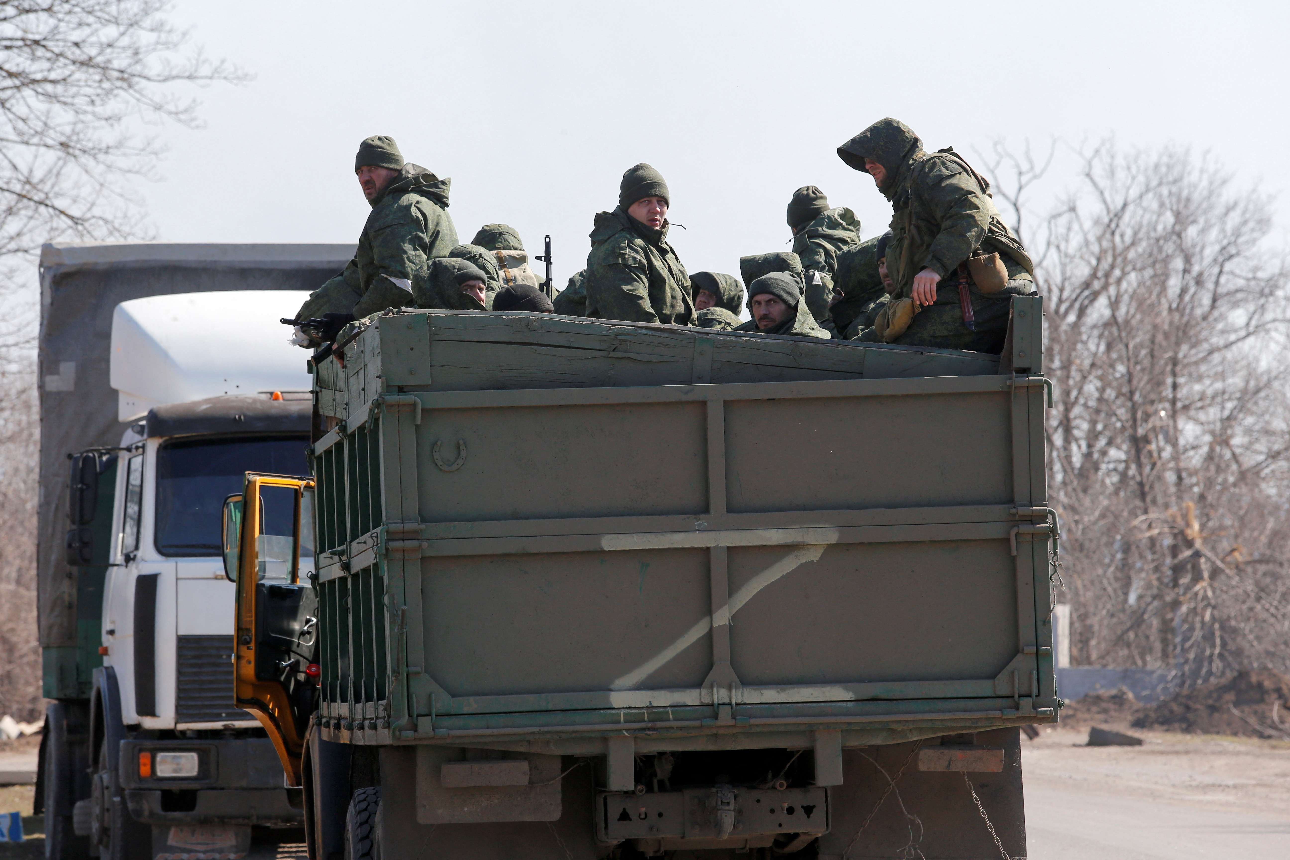 Service members of pro-Russian troops are seen near the besieged city of Mariupol