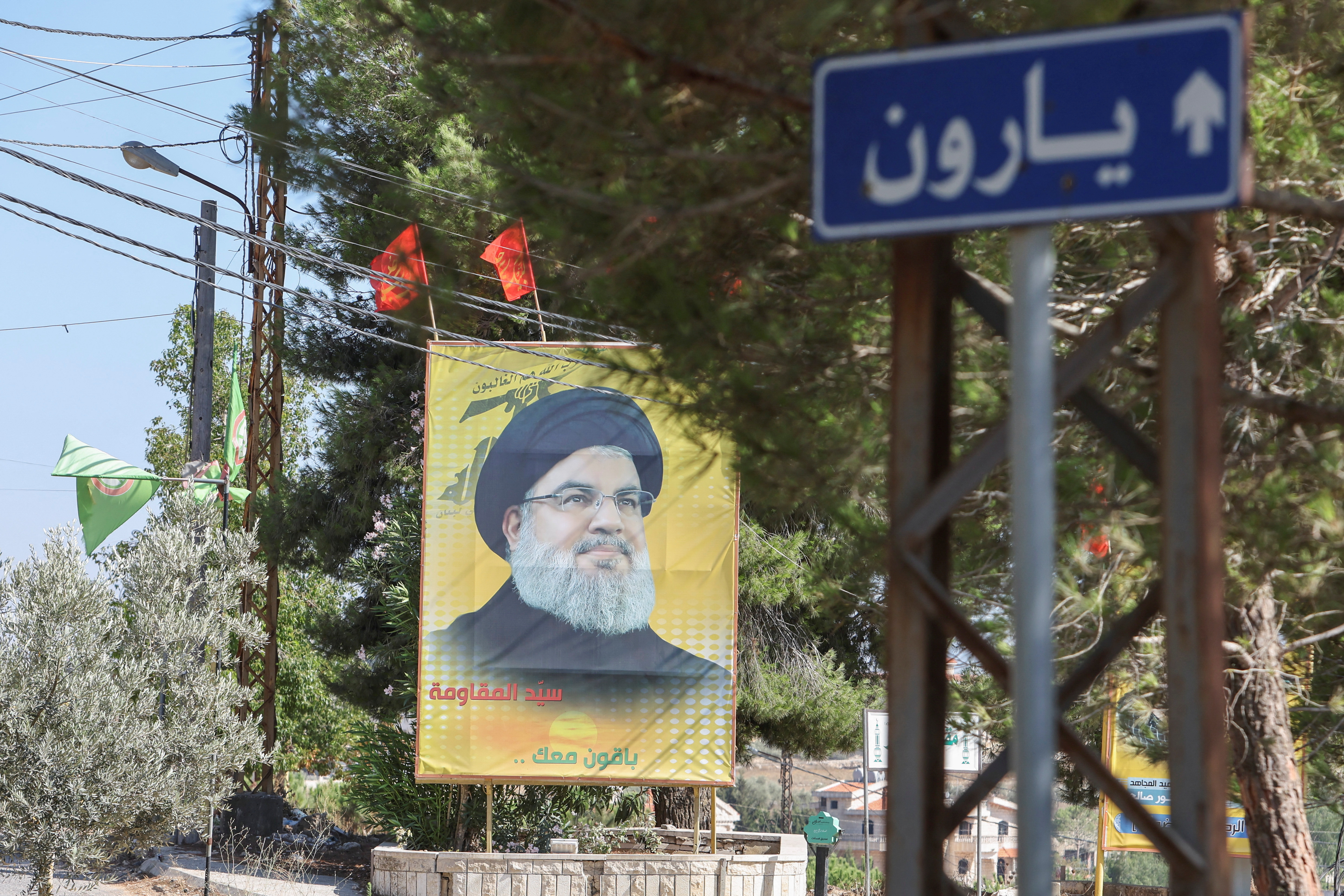 A poster depicting Lebanon's Hezbollah leader Sayyed Hassan Nasrallah is placed in Yaroun