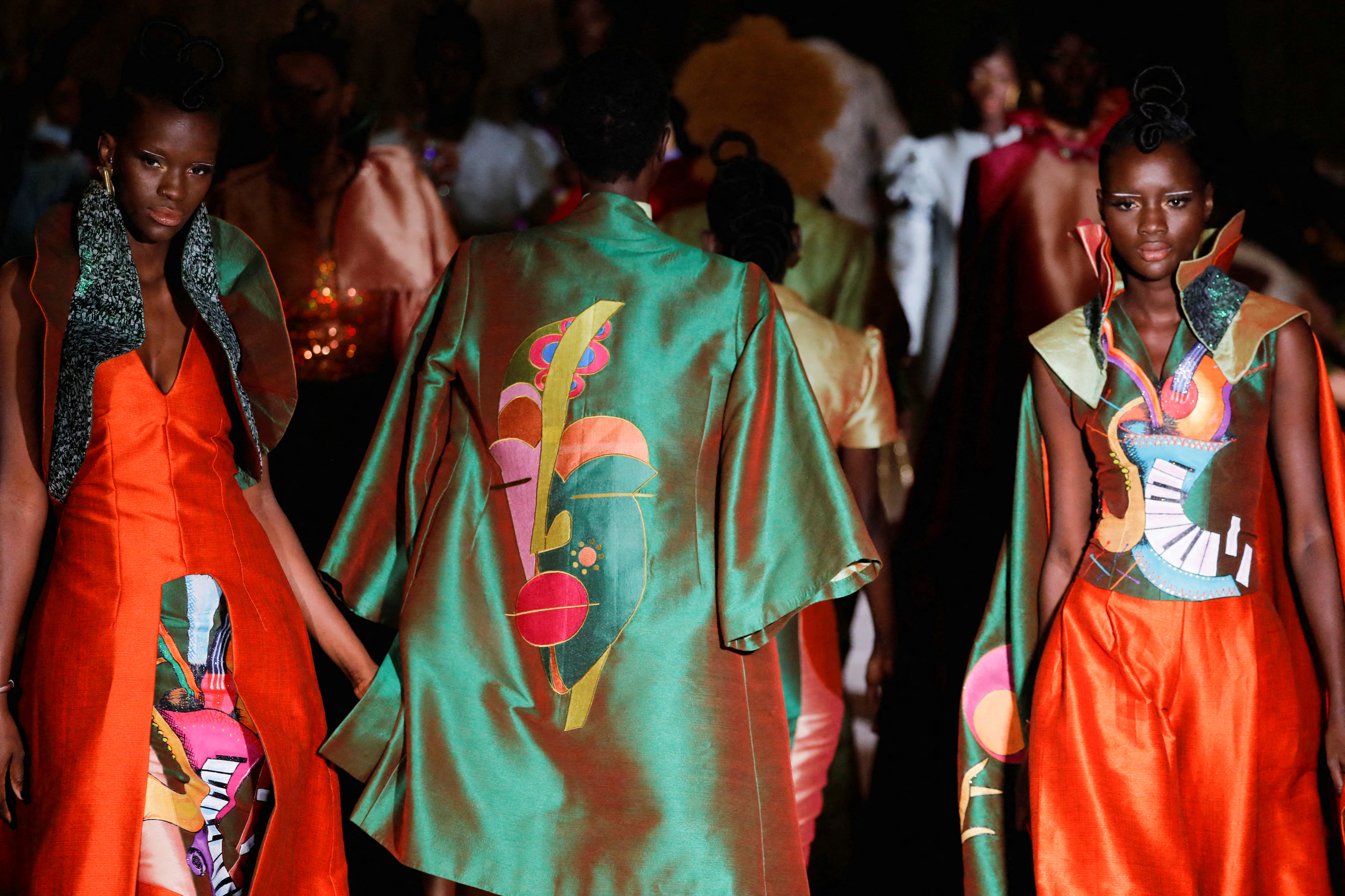 Models present creations by Al Gueye designer during the 19th annual Dakar Fashion Week at the Baobad forest, in Mbour