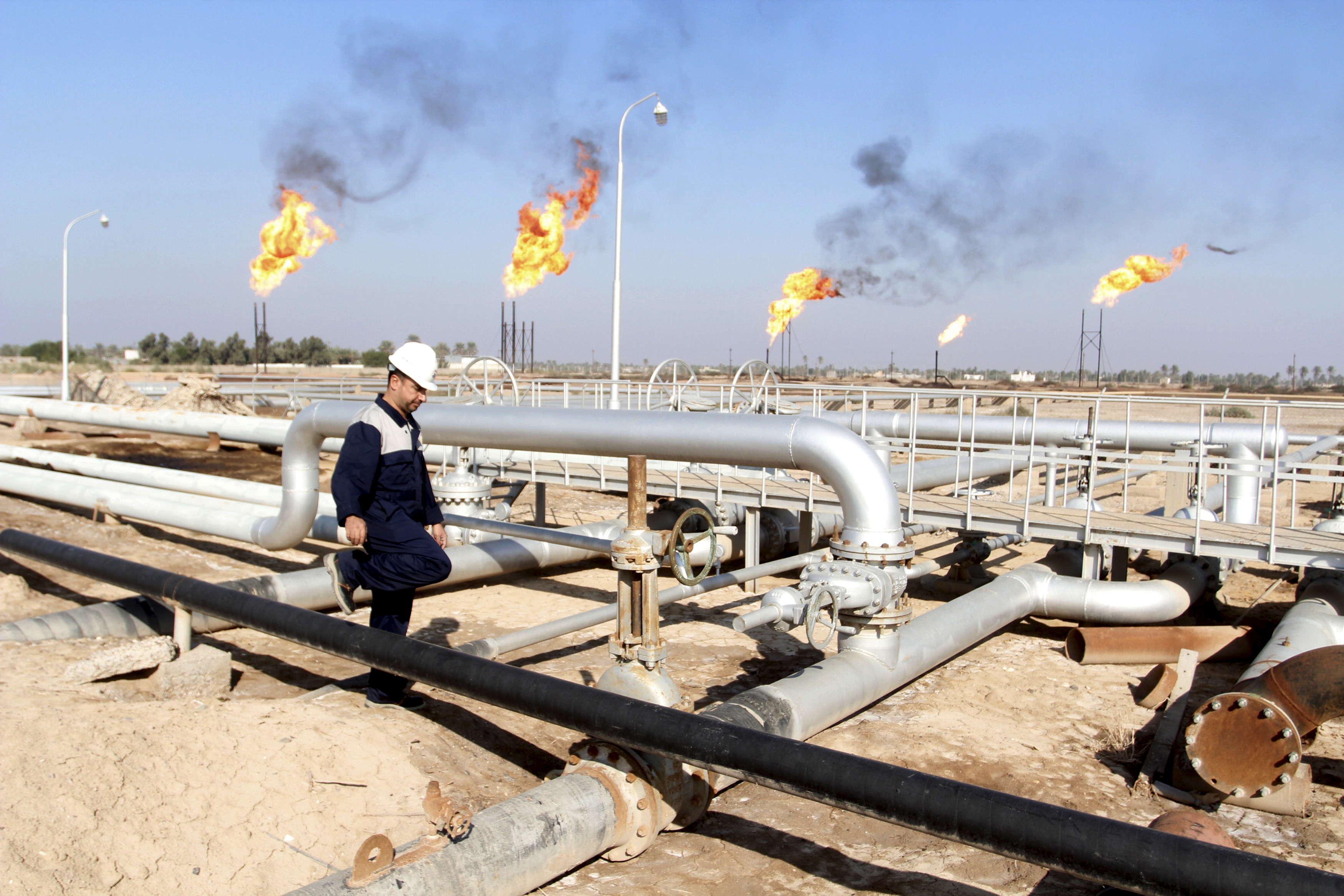 A worker walks at Nahr Bin Umar oil field, north of Basra