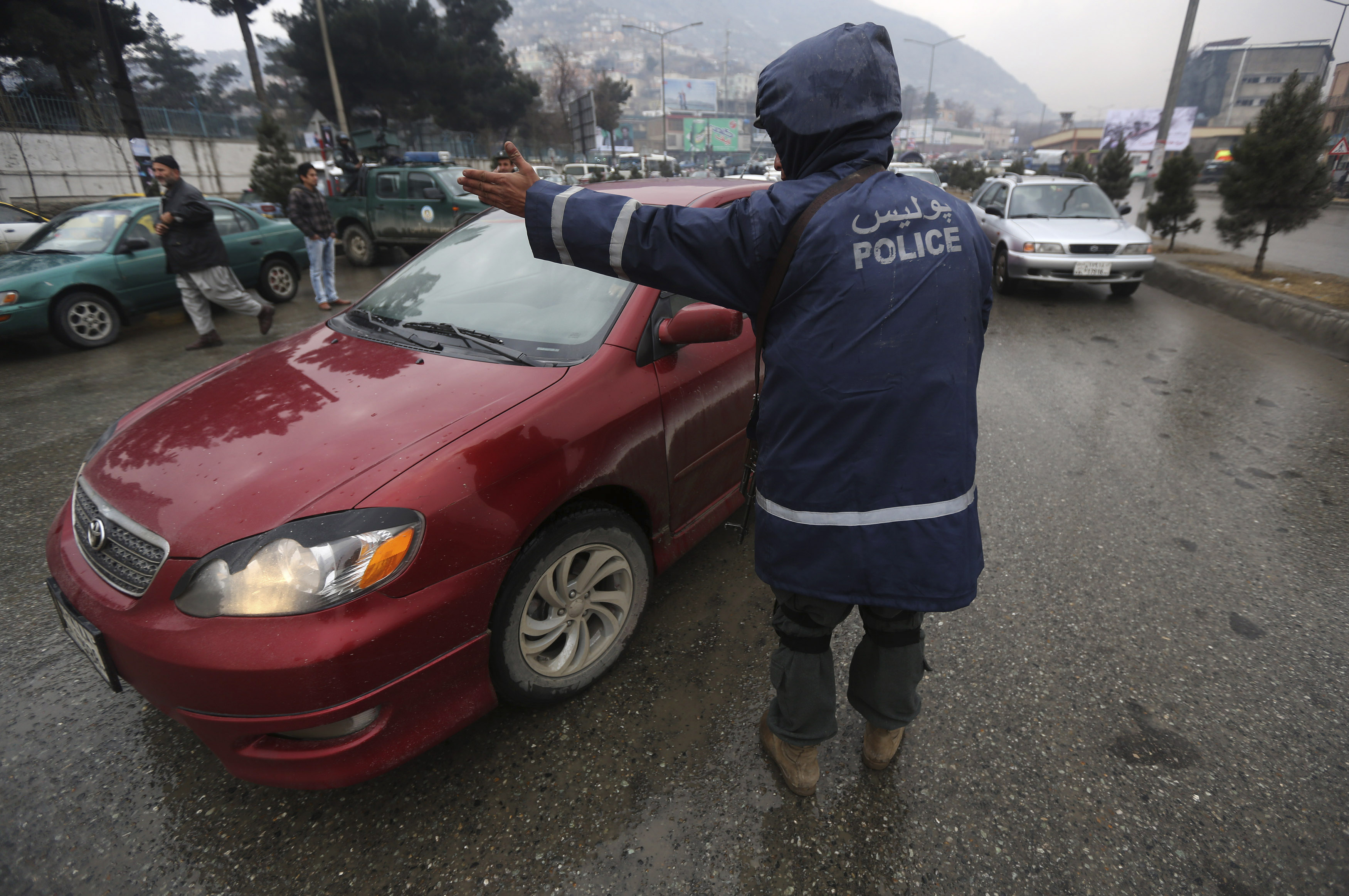An Afghan police officer mans a checkpoint during the first day of the presidential election campaign in Kabul