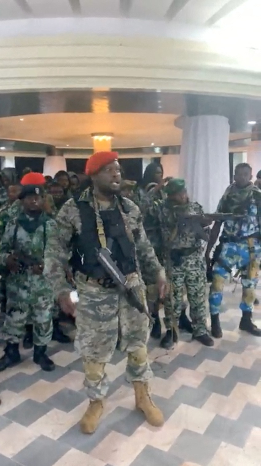 A man in military fatigues speaks inside the Palace of the Nation during an attempted coup in Kinshasa