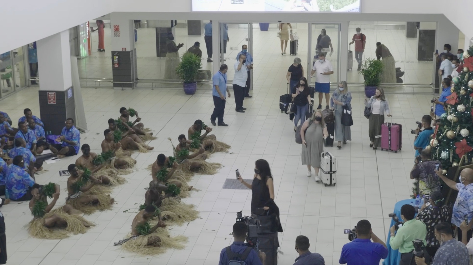 Performers greet travellers in the terminal upon arrival at Nadi Airport, Fiji in this still frame obtained from handout video dated December 1, 2021