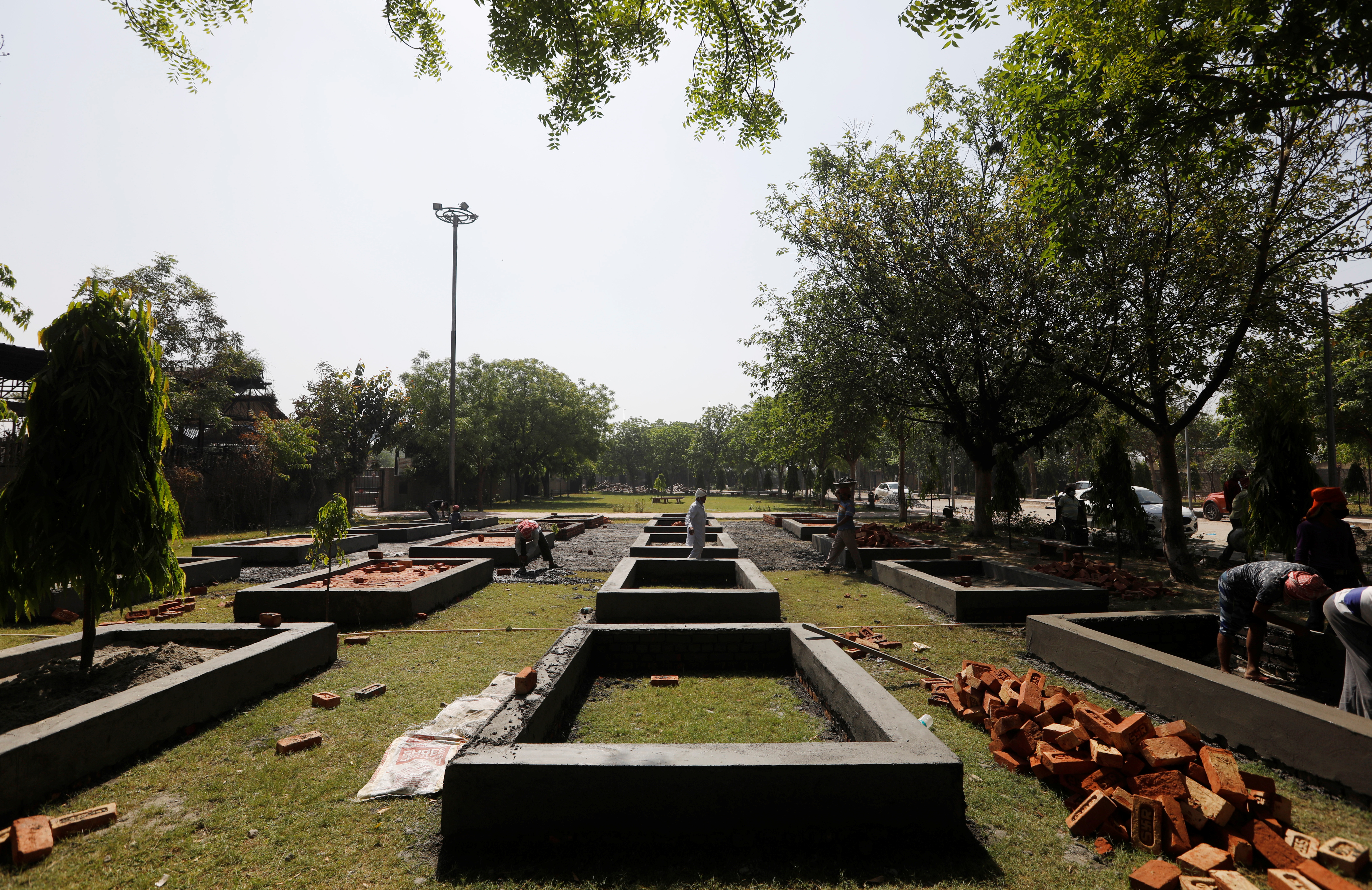 Workers build new platforms to cremate bodies inside a crematorium, amid the spread of the coronavirus disease (COVID-19) in New Delhi, India, April 26, 2021. REUTERS/Adnan Abidi