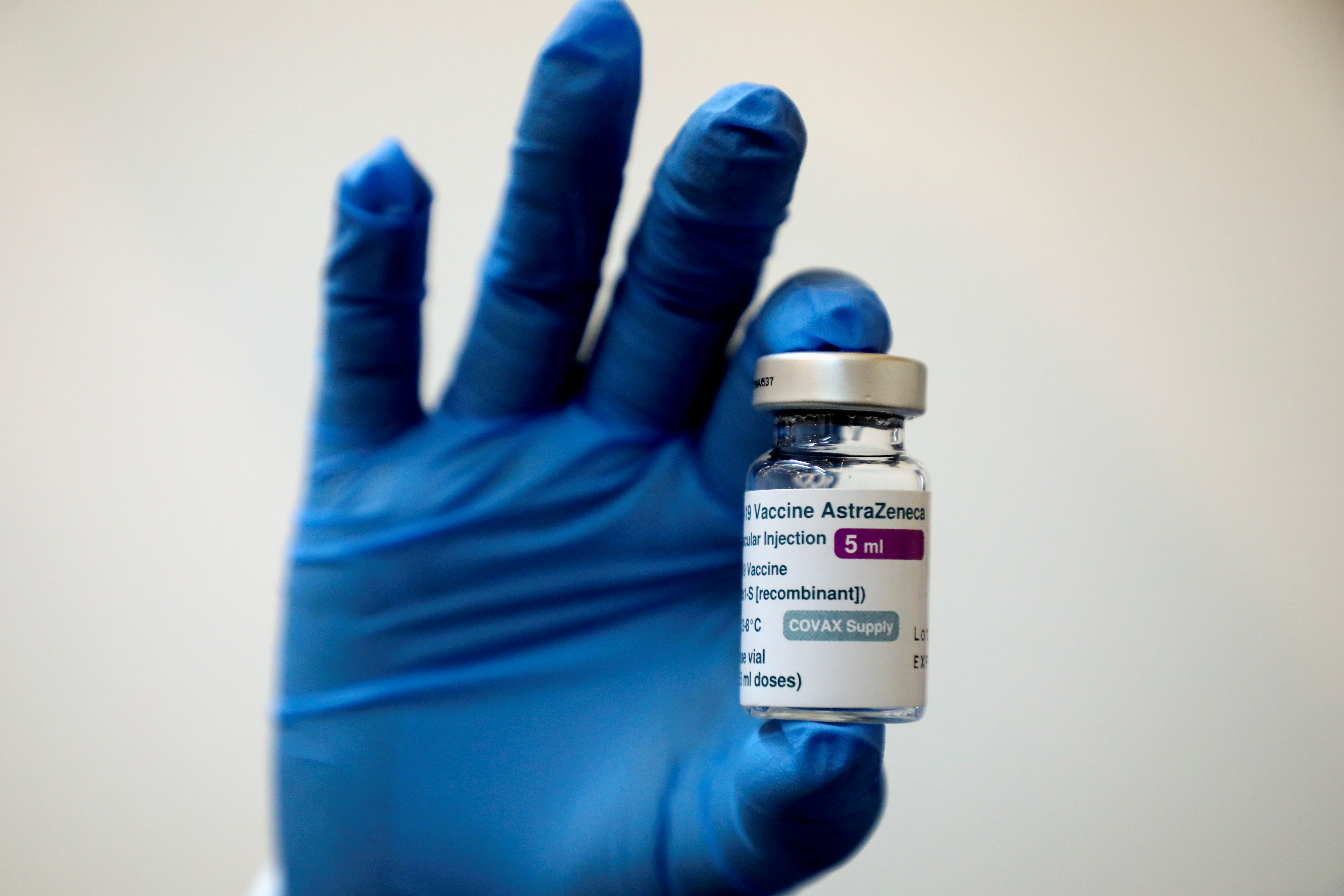 A medical worker holds a bottle of AstraZeneca's COVID-19 vaccine in this file photo