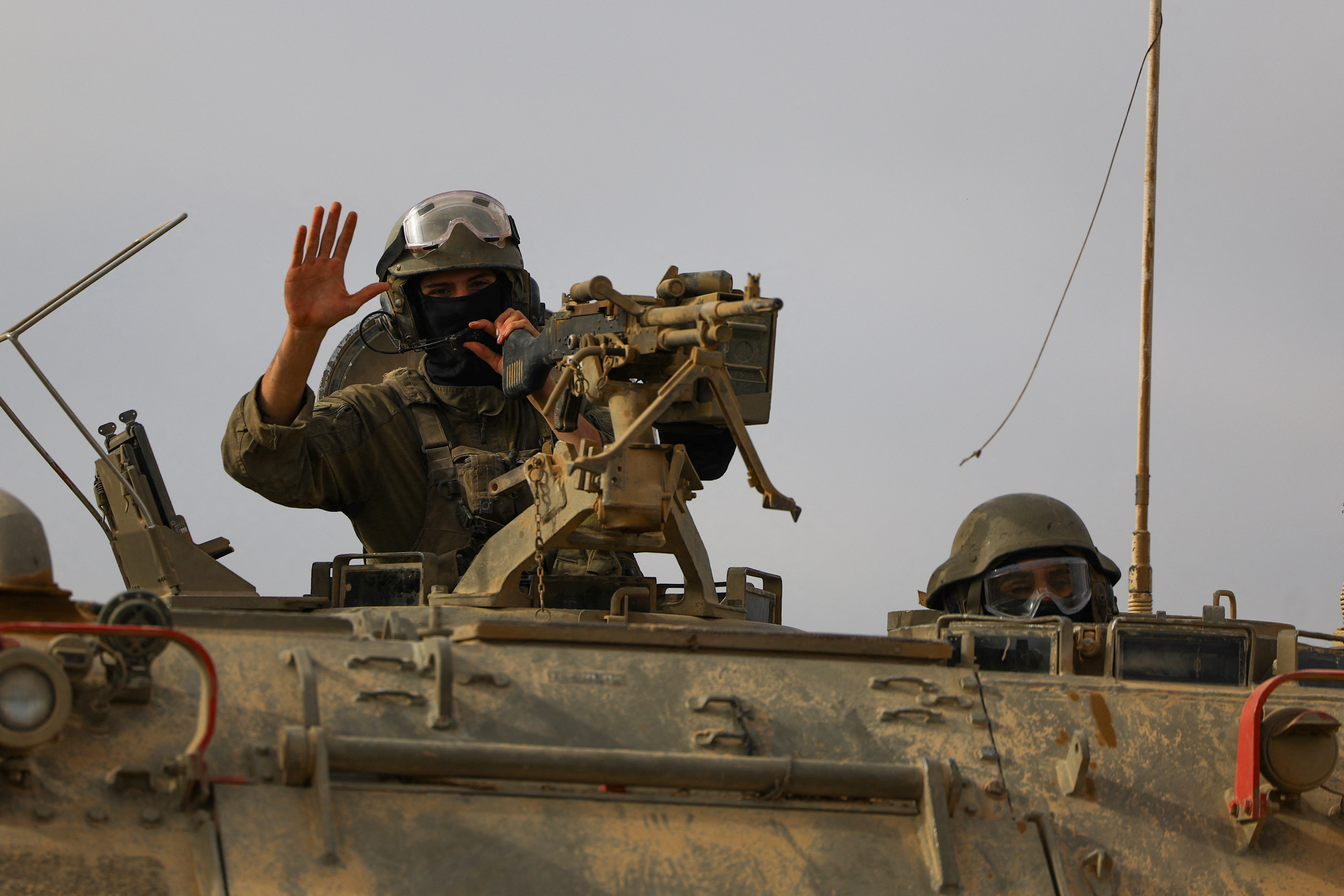 Israeli military personnel drive near the Israel-Gaza border