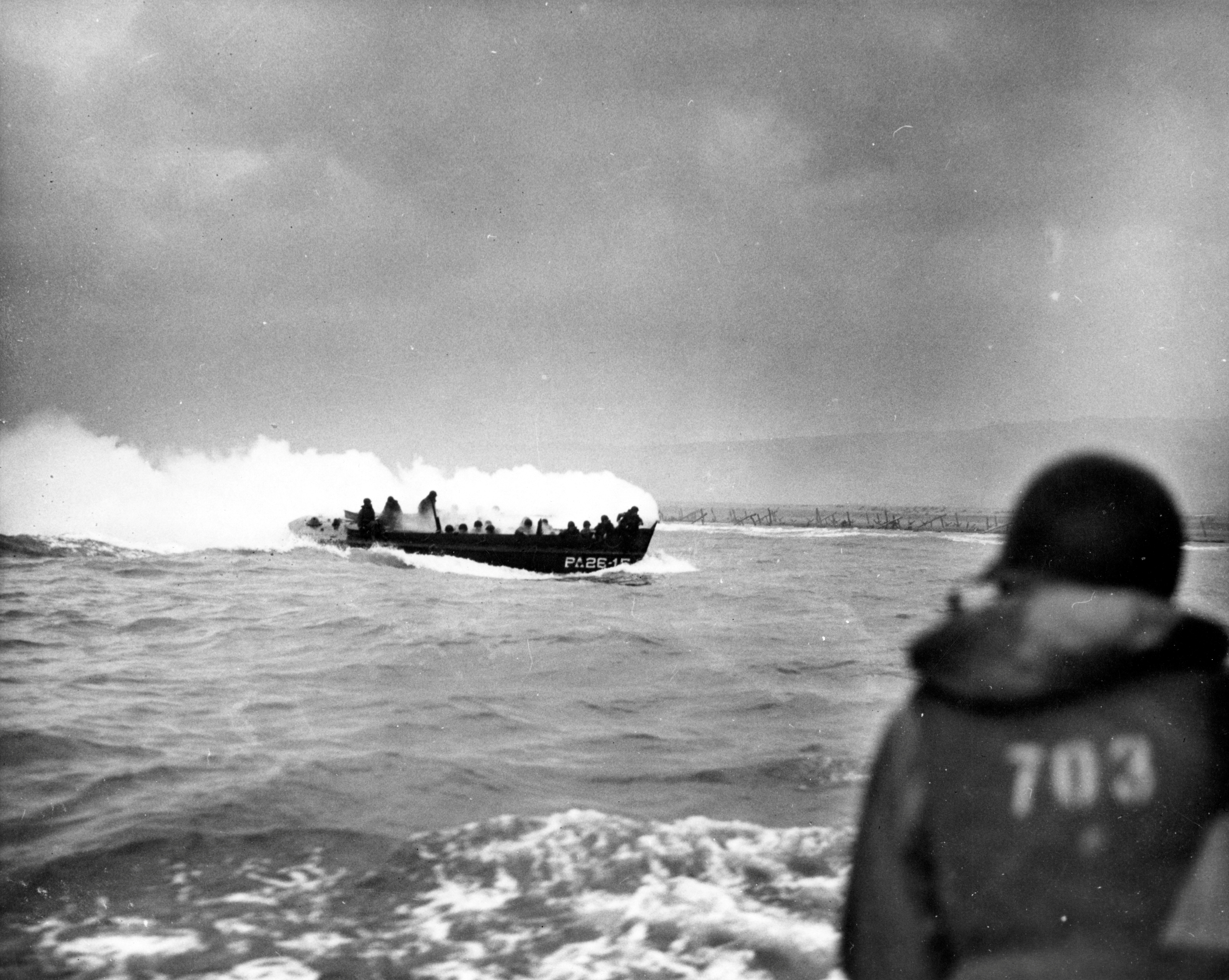 A LCVP landing craft from the U.S. Coast Guard attack transport USS Samuel Chase approaches Omaha Beach on D-Day in Colleville Sur-Mer