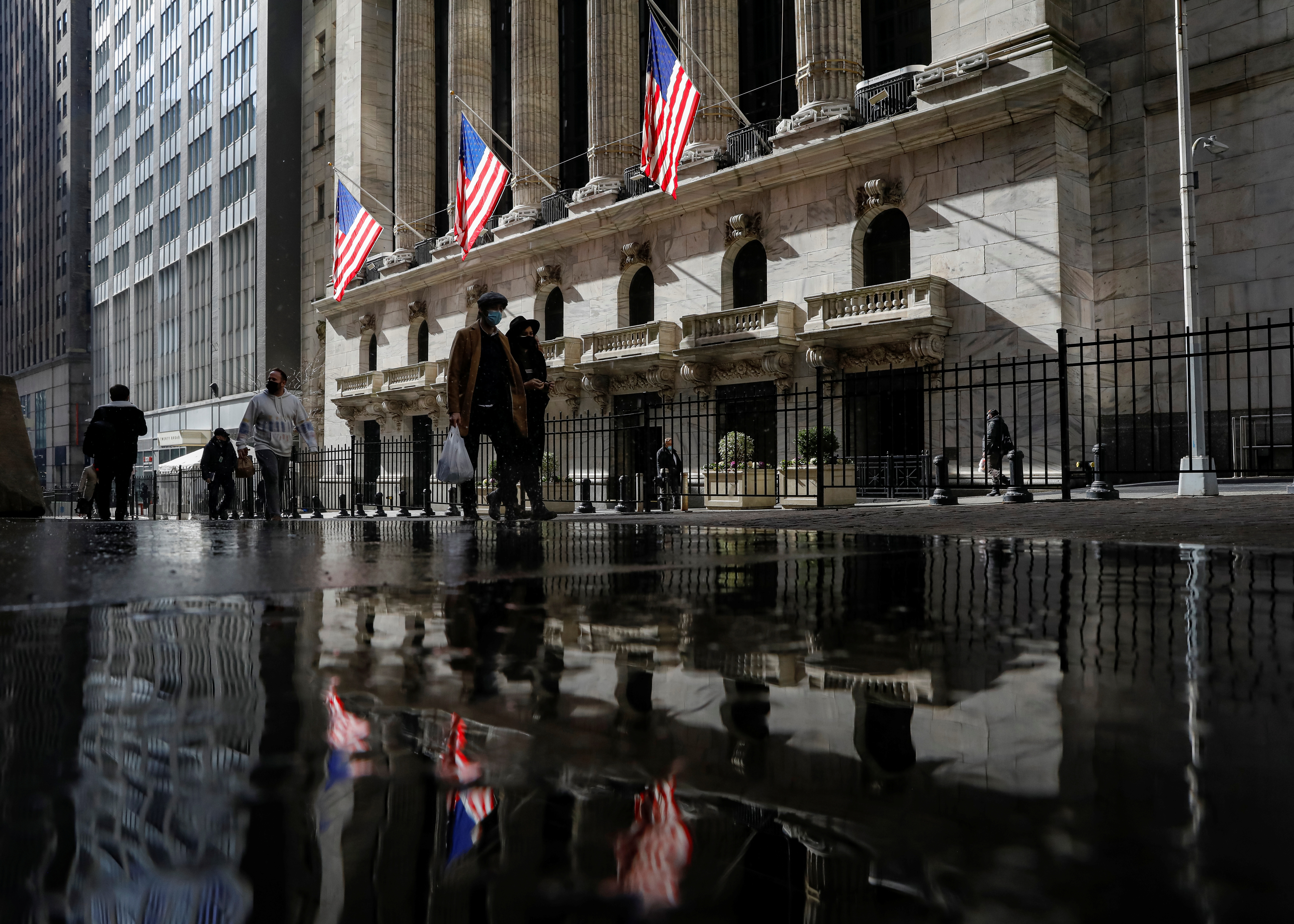 U.S. flags fly out in front of the NYSE is seen in New York