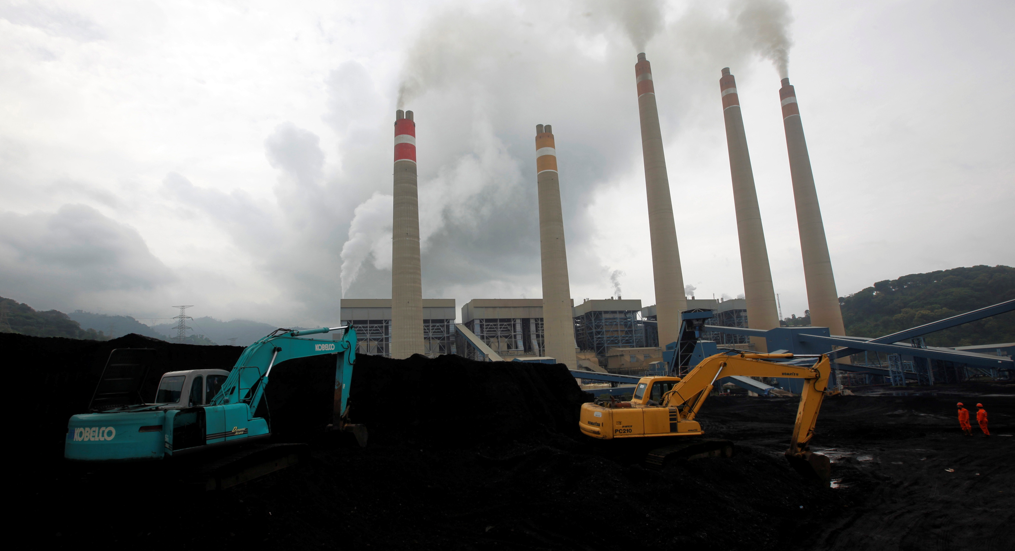 Excavators pile coal in a storage area in an Indonesian Power Plant in Suralaya, in Banten province January 20, 2010.