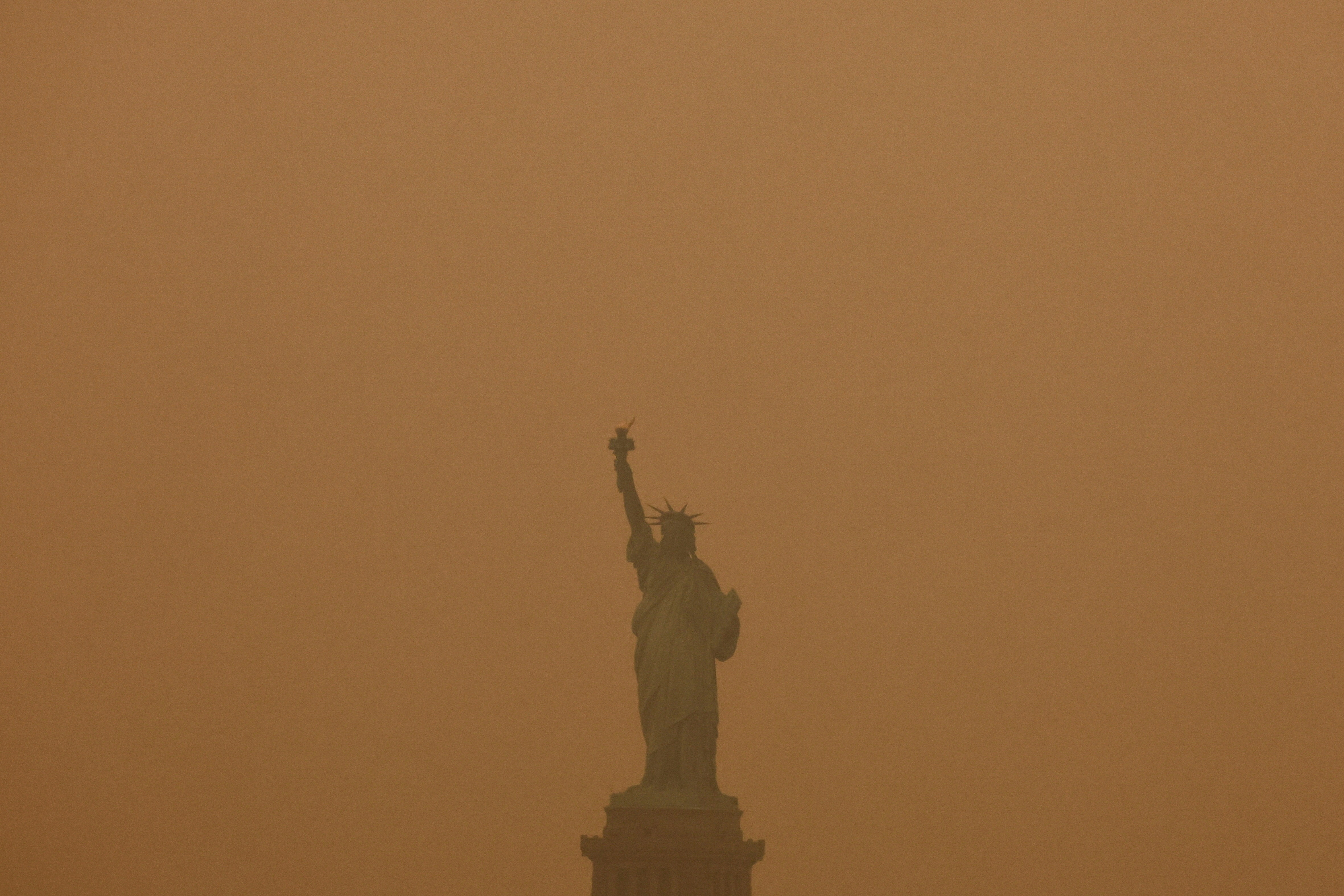 The Statue of Liberty is covered in haze and smoke caused by wildfires in Canada, in New York