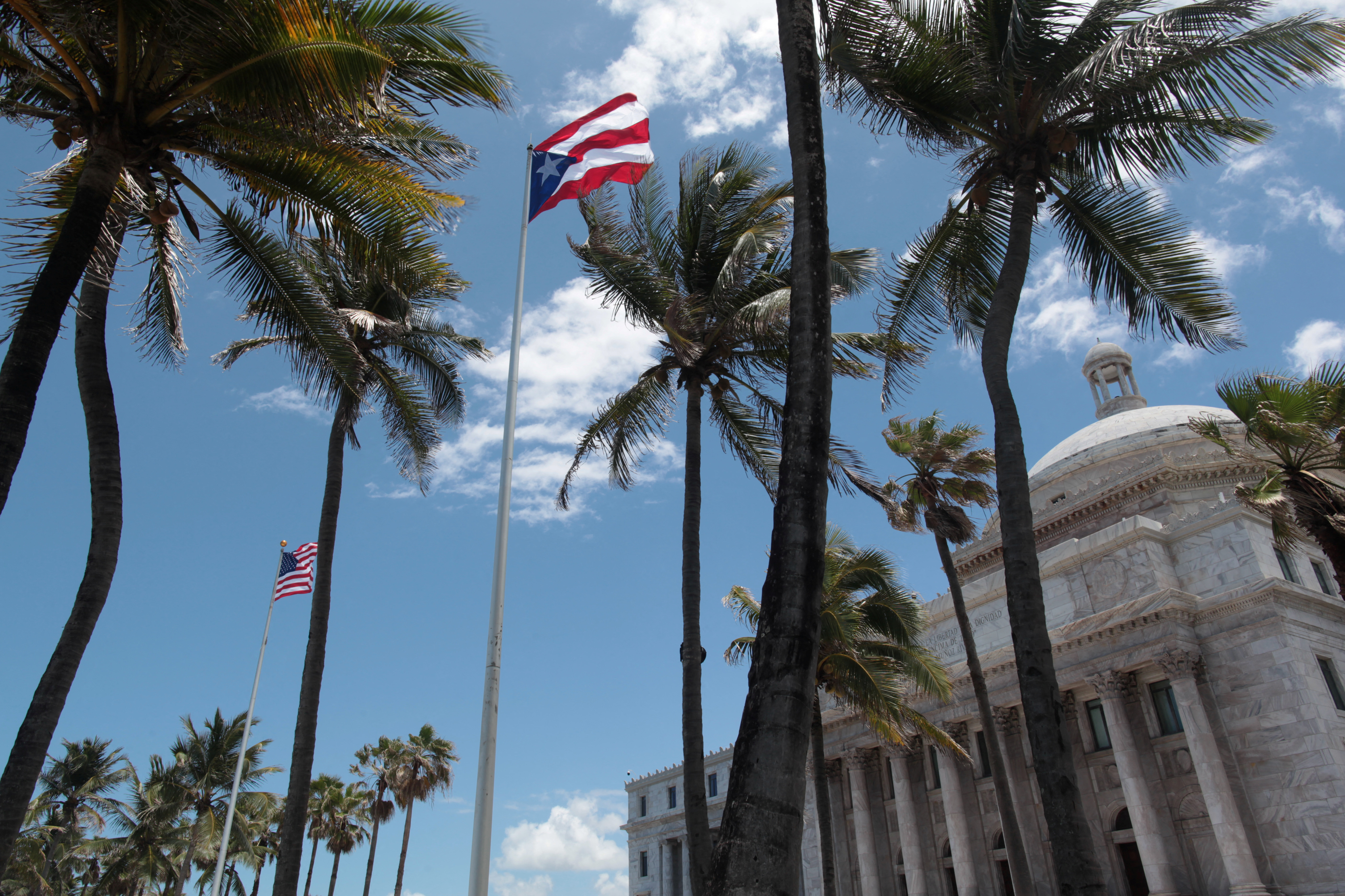 The flags of the U.S. and Puerto Rico fly outside the Capitol building in San Juan