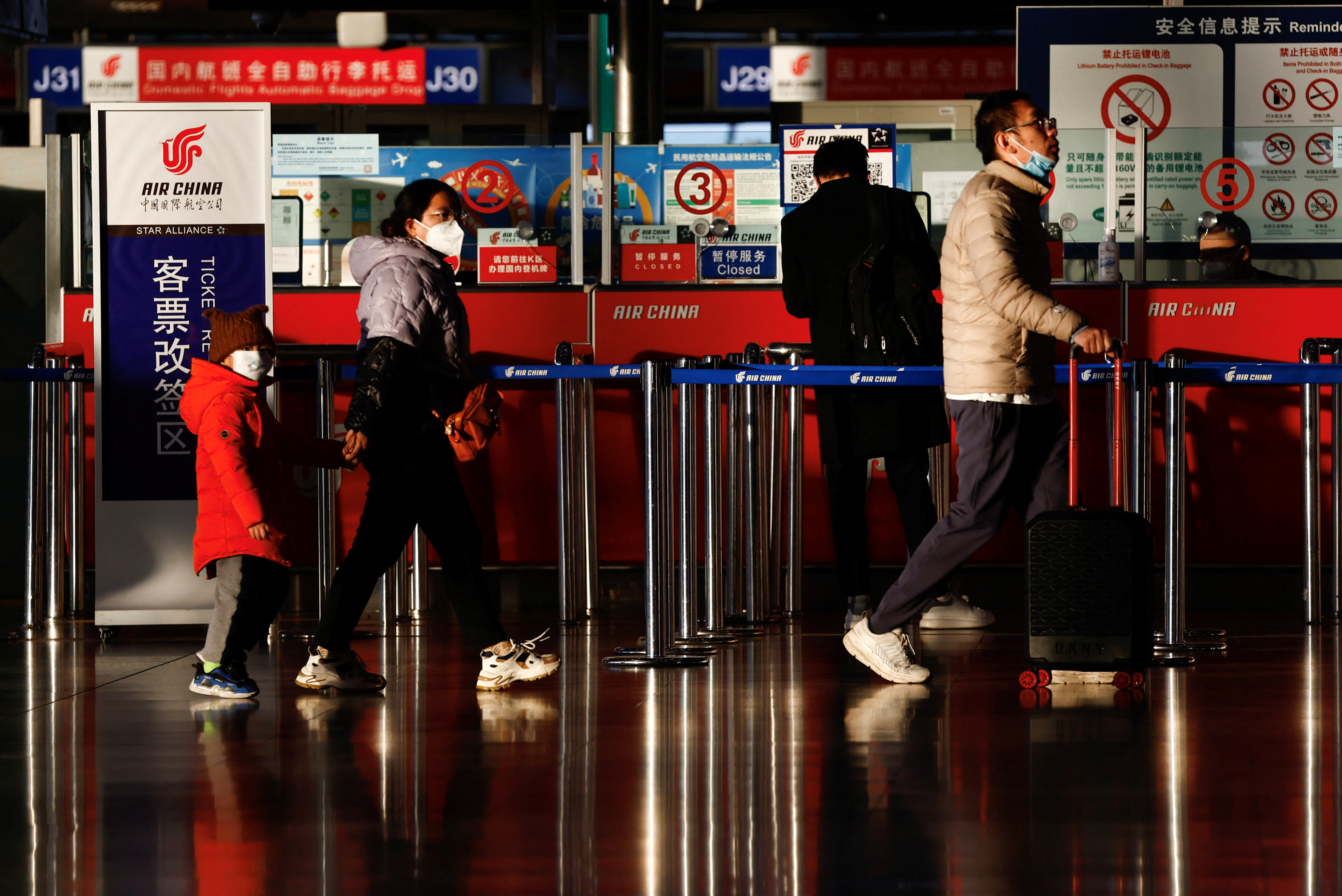 Travellers walk at the during the annual Spring Festival travel rush at Beijing Capital International Airport