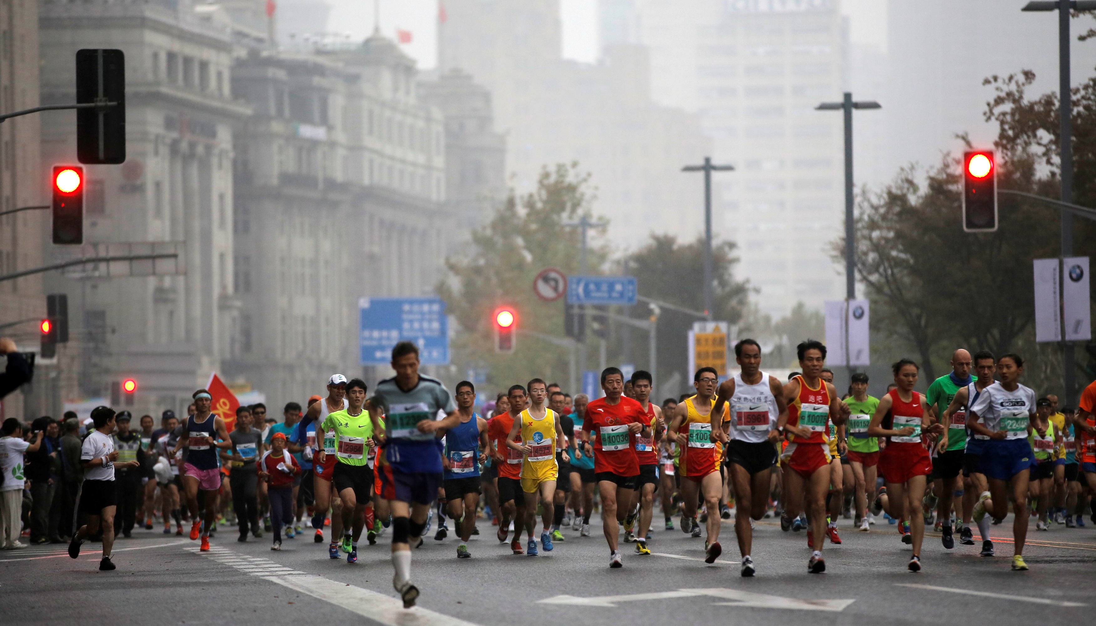 Participants run on the Bund near Huangpu River as they compete in the Shanghai International Marathon