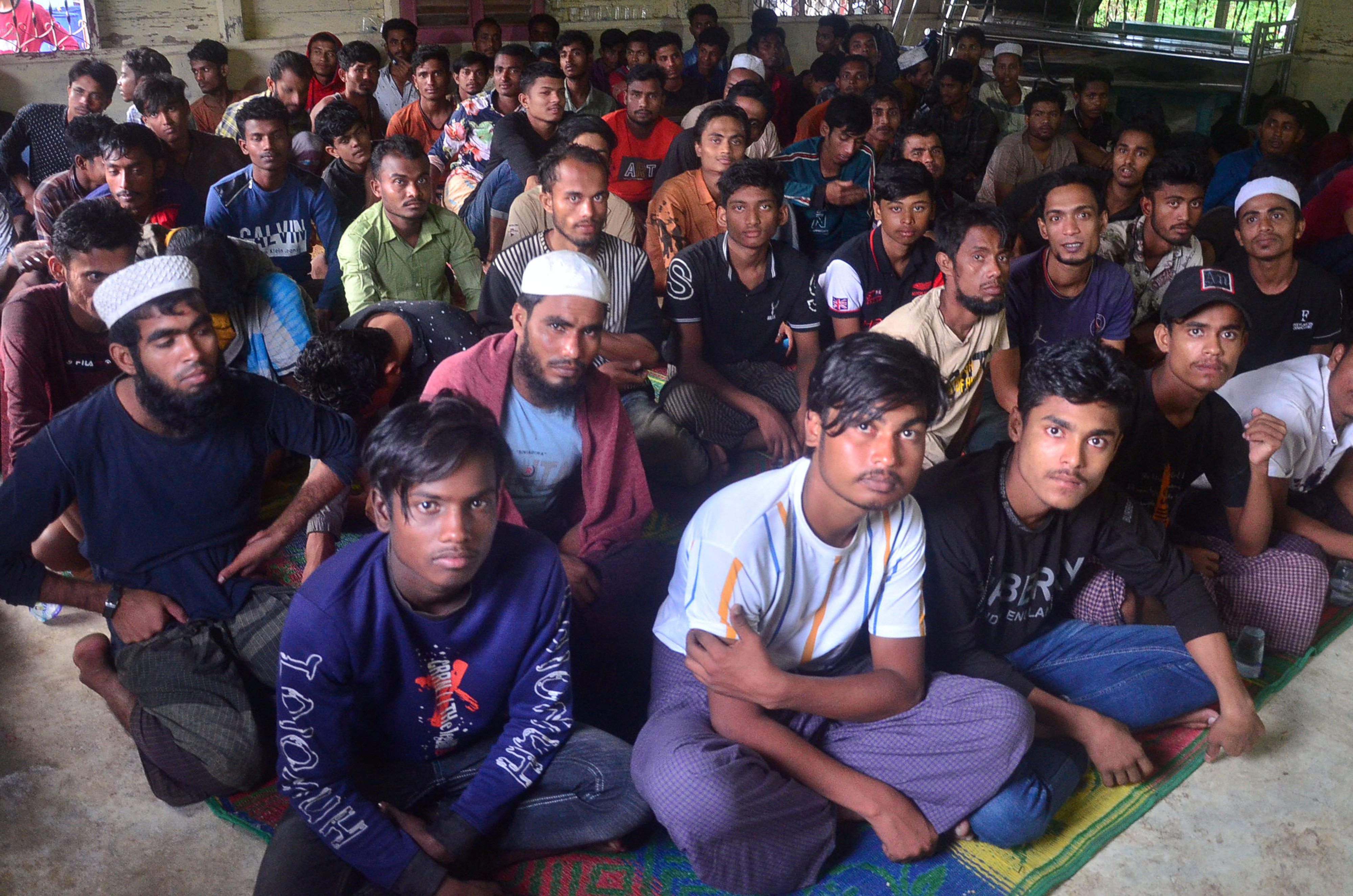 Rohingya refugees sit inside a temporary shelter after they landed in Kuala Matang Peulawi