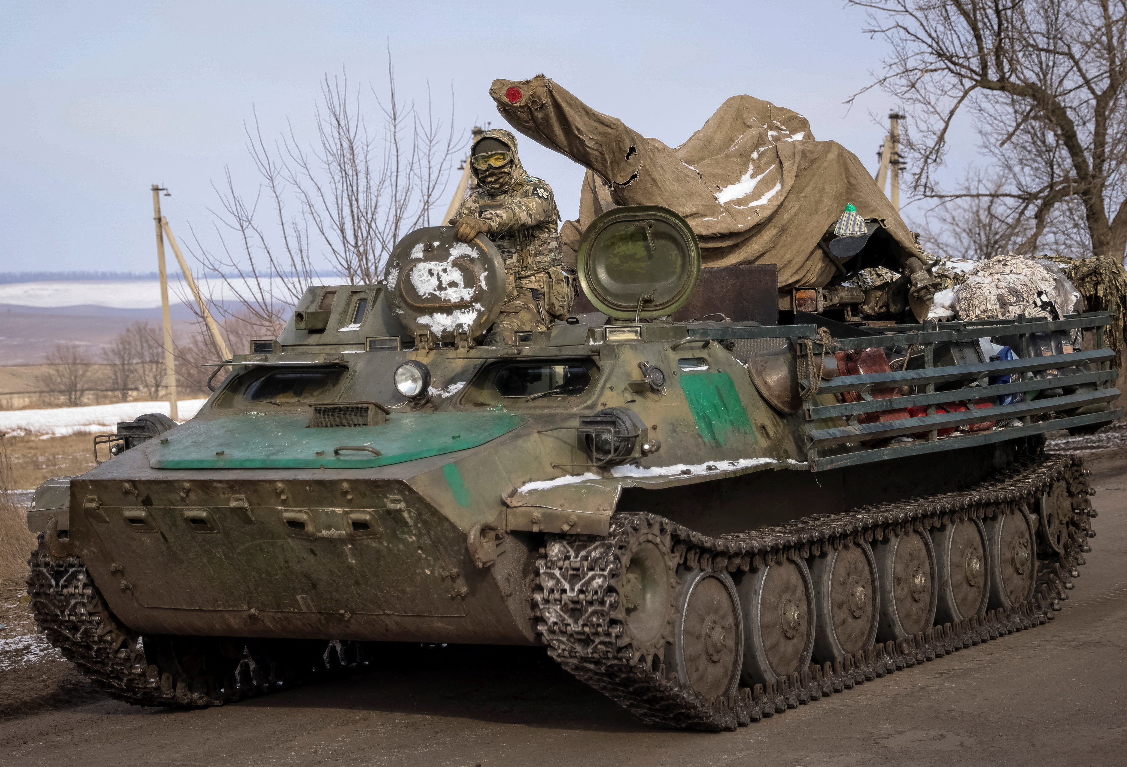 Ukrainian serviceman rides a military vehicle in the front line city of Bakhmut