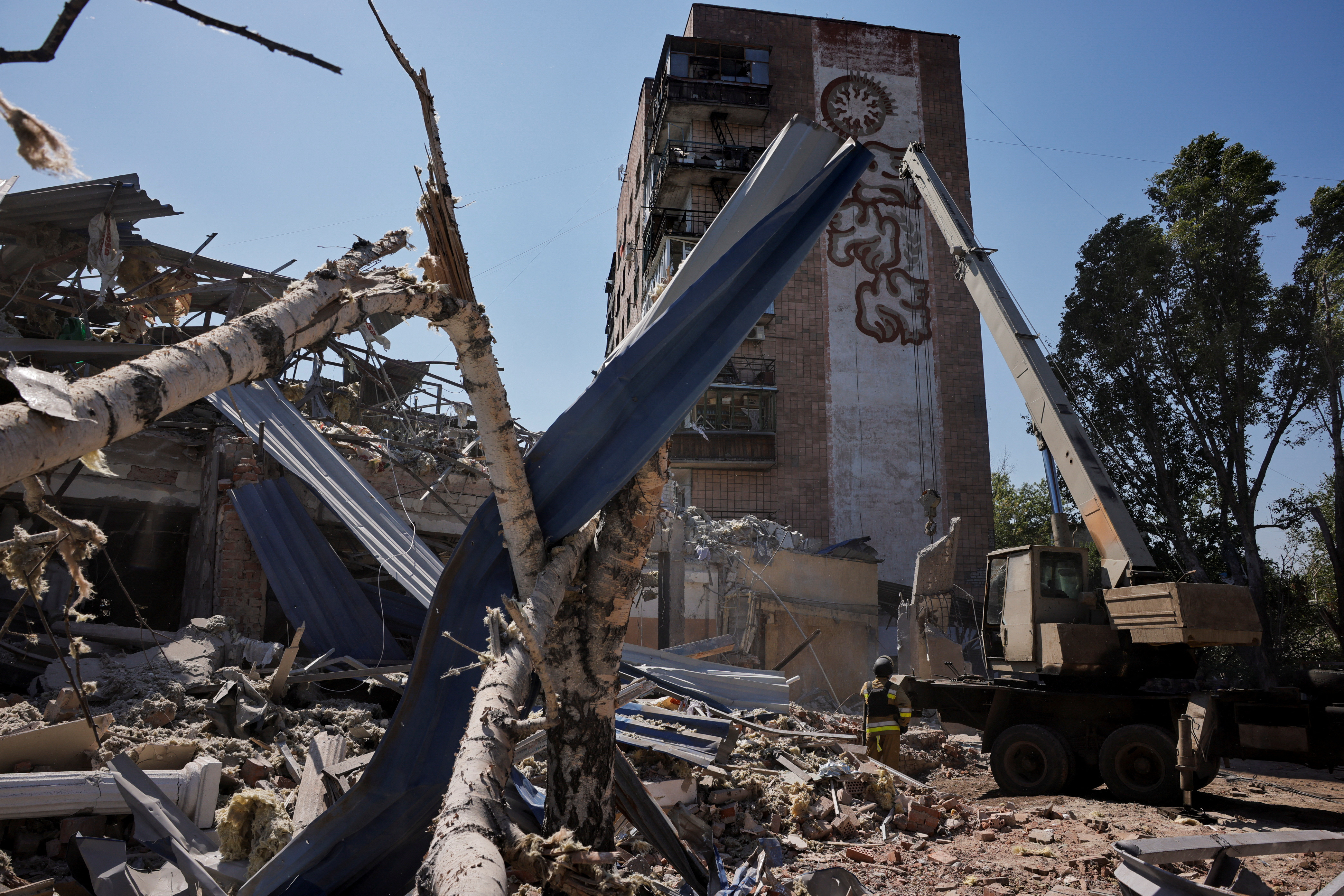 Ukrainian emergency personnel work among the rubble of a destroyed hotel following a Russian strike, in Kramatorsk