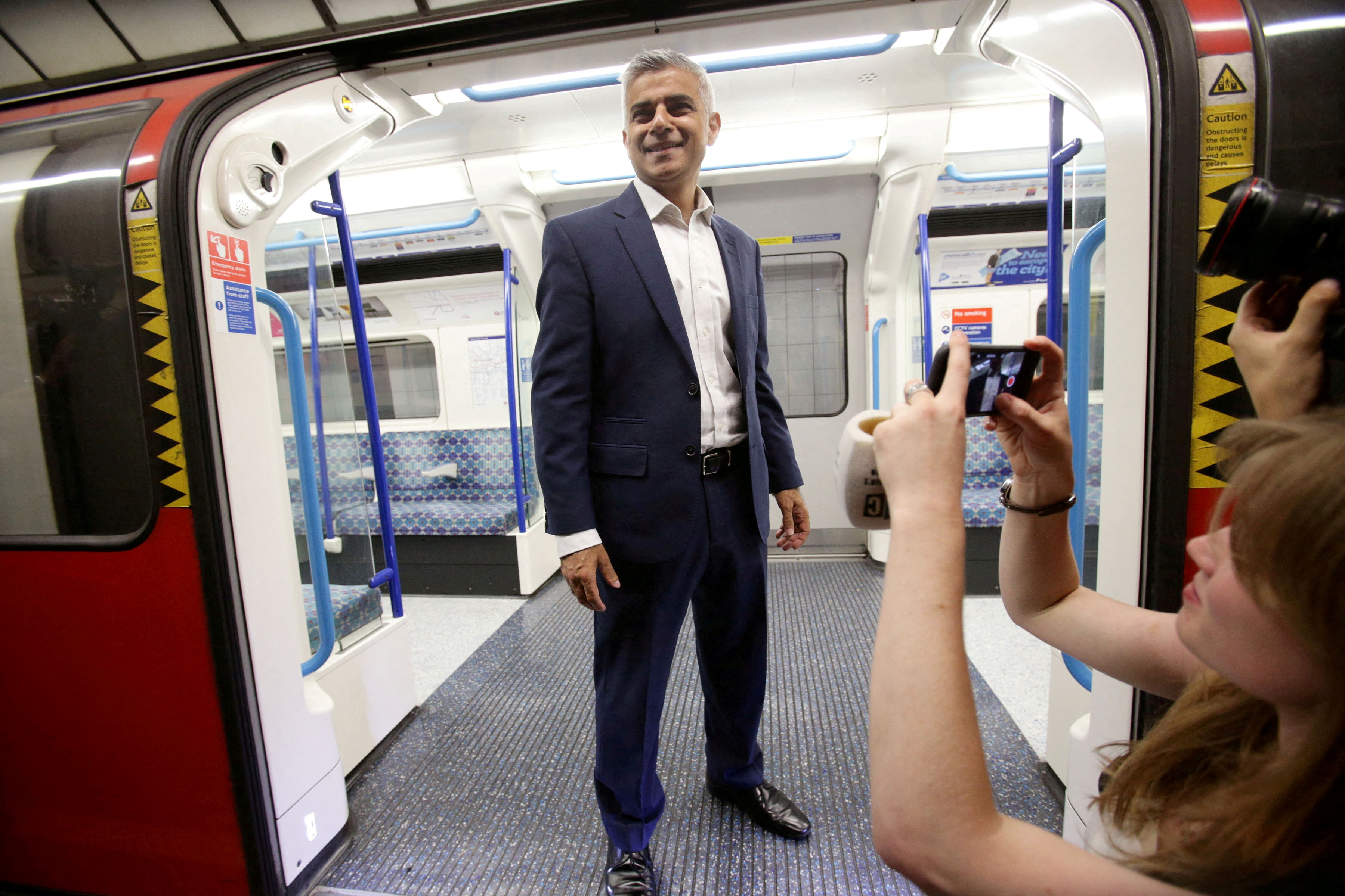 Mayor of London Sadiq Khan poses for the media on a Victoria line tube train carriage at Brixton Underground station, during the launch of London's Night Tube