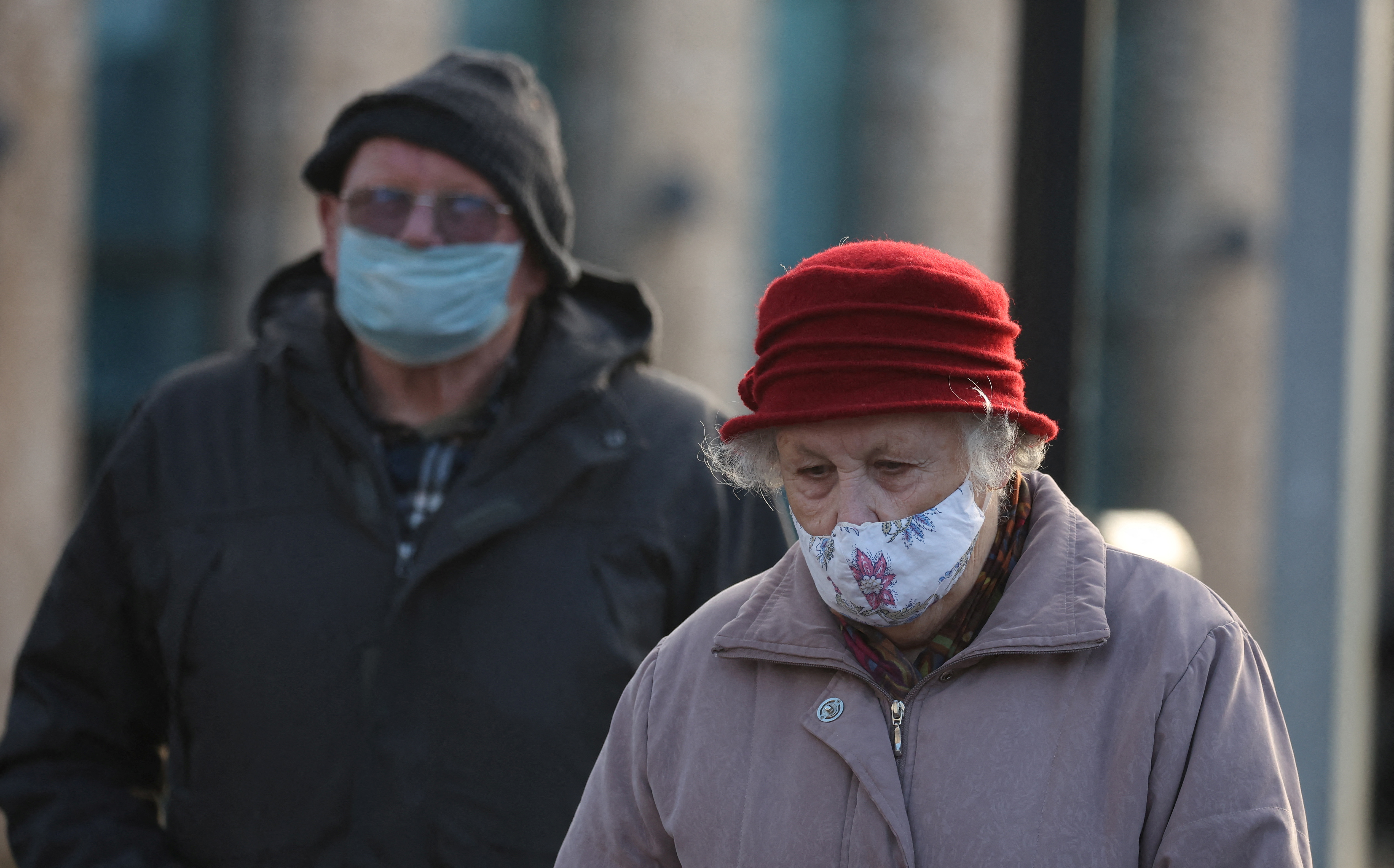 People wearing face masks walk through the town centre, amid the coronavirus disease (COVID-19) outbreak in Bolton