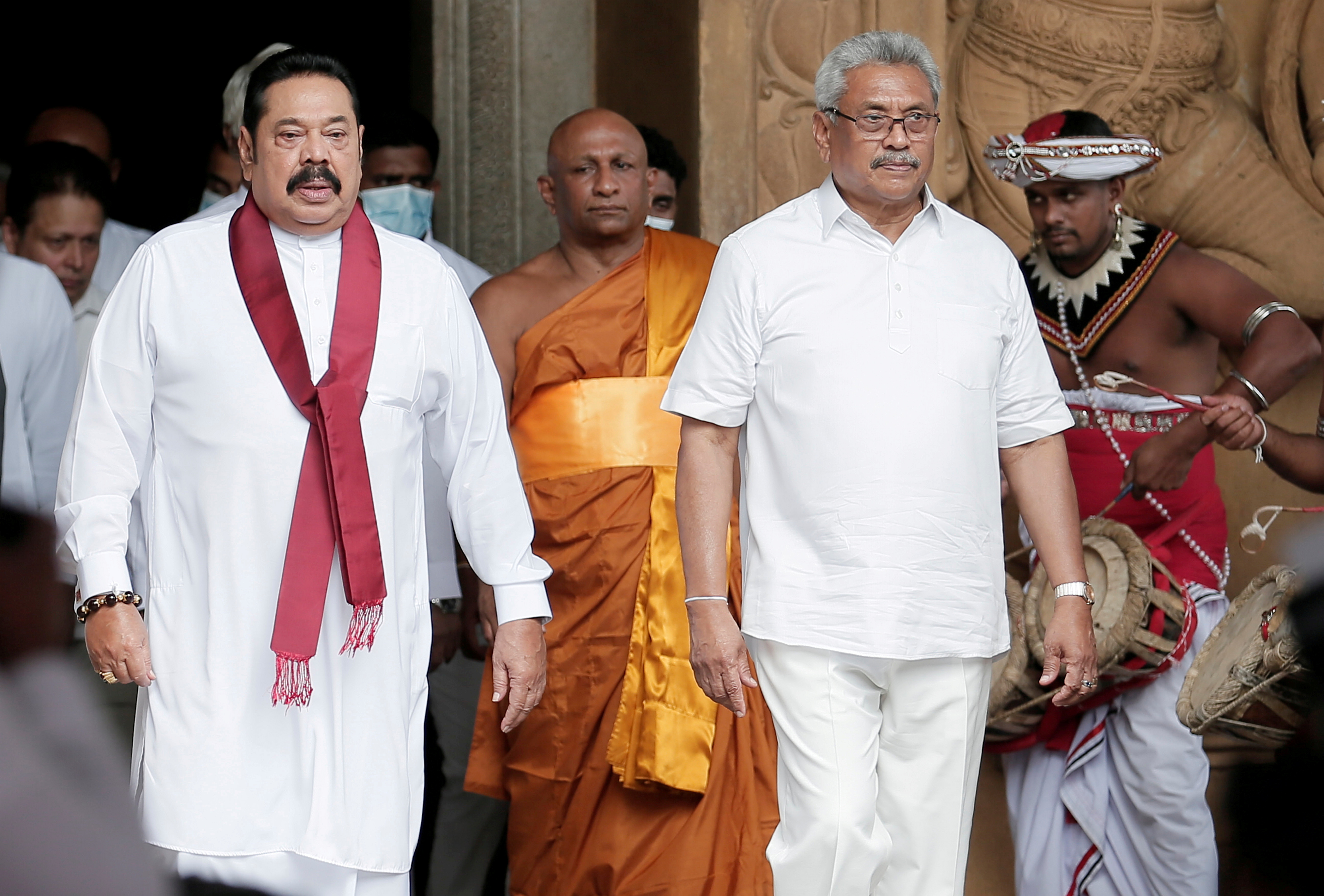 Sri Lanka's Prime Minister Mahinda Rajapaksa and his brother, and Sri Lanka's President, Gotabaya Rajapaksa are seen during his during the swearing in ceremony as the new Prime Minister, at Kelaniya Buddhist temple in Colombo, Sri Lanka, August 9, 2020. REUTERS/Dinuka Liyanawatte/File Photo