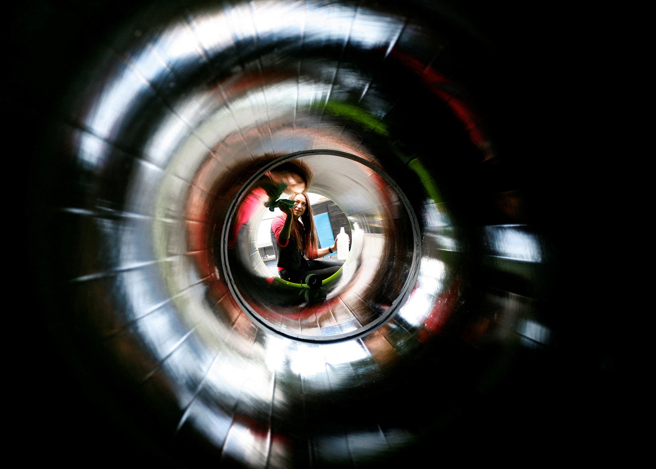 Woman cleans inside of exhibit representing natural gas pipeline during final preparations at the Hannover Messe industrial trade fair in Hannover