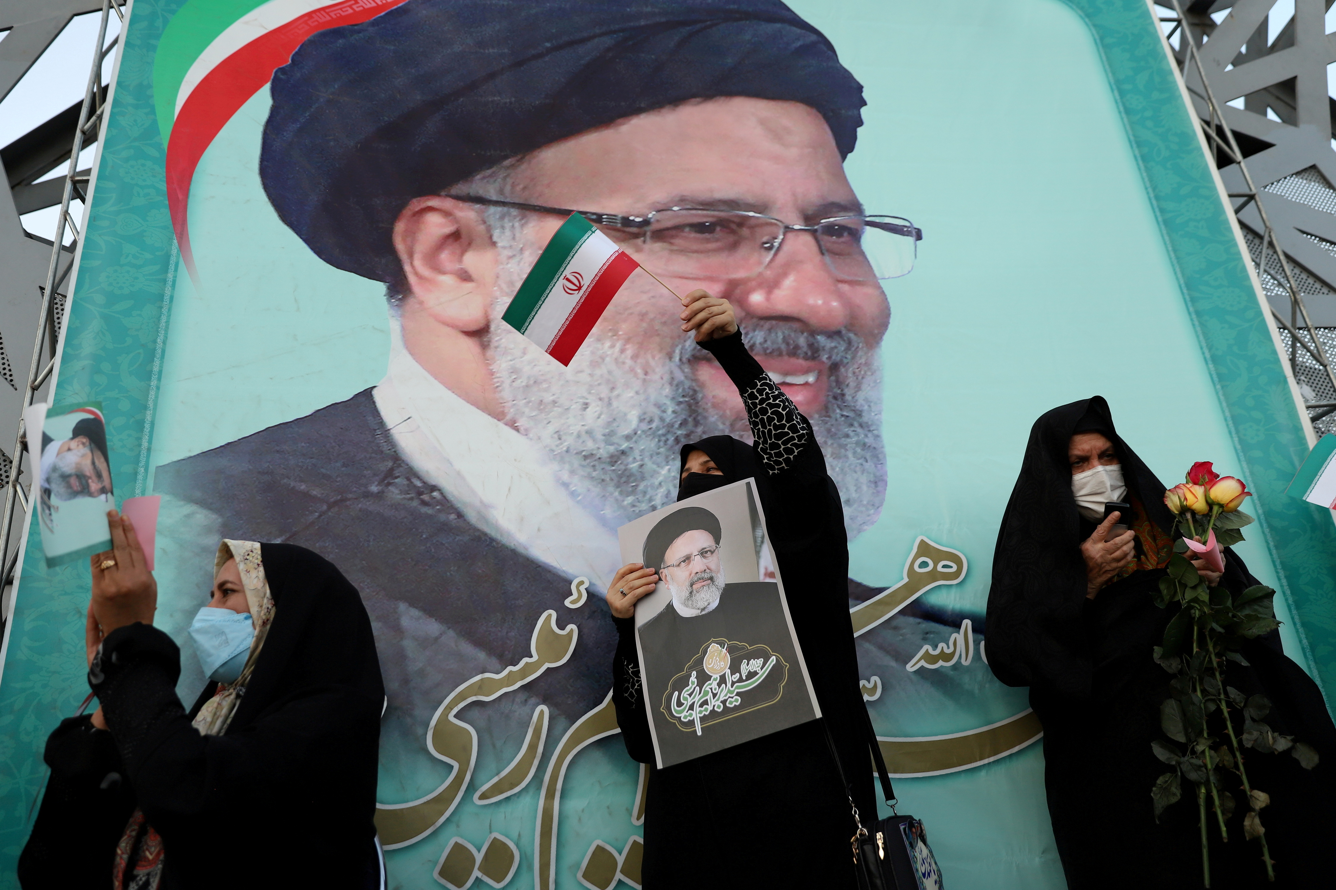 A supporter of Ebrahim Raisi displays his portrait during a celebratory rally for his presidential election victory in Tehran, Iran June 19, 2021.