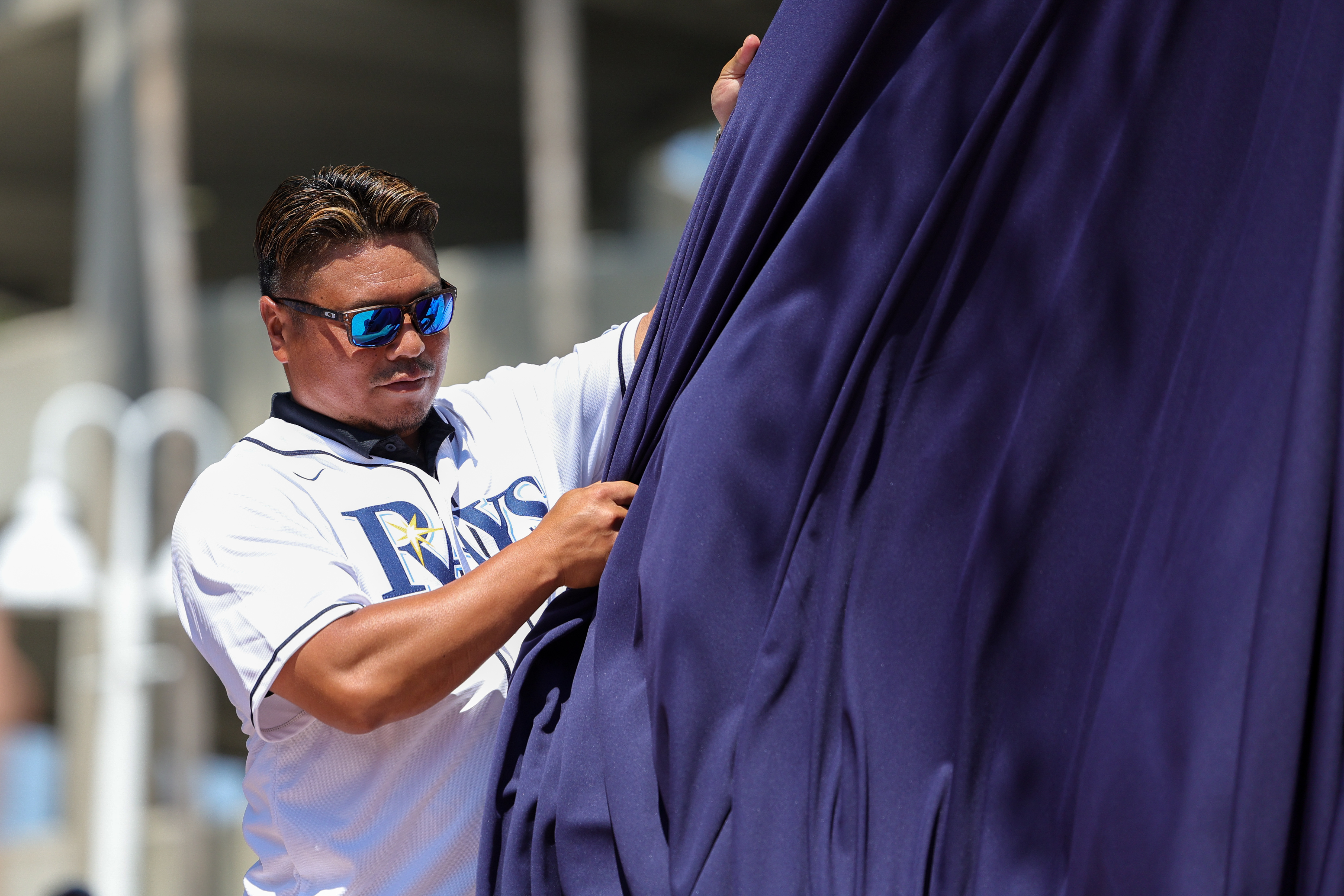 A fan wearing a Toronto Blue Jays jersey holds a sign for