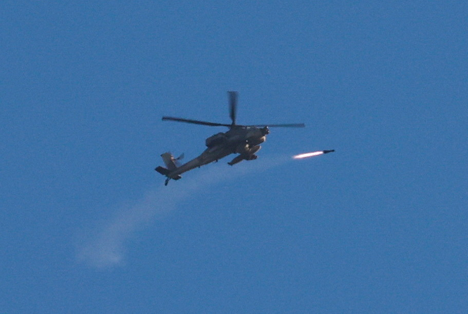 An Apache helicopter fires a missile as seen from Sderot