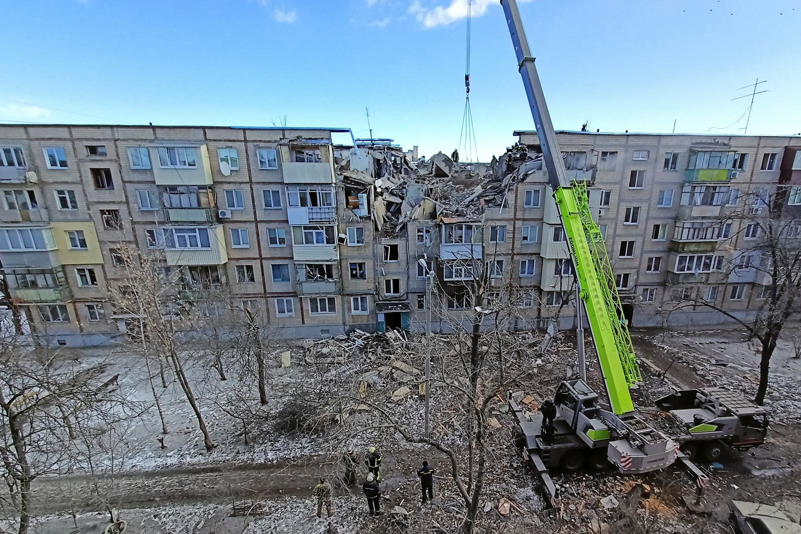 Rescuers remove debris from a residential building damaged by an airstrike in Kharkiv