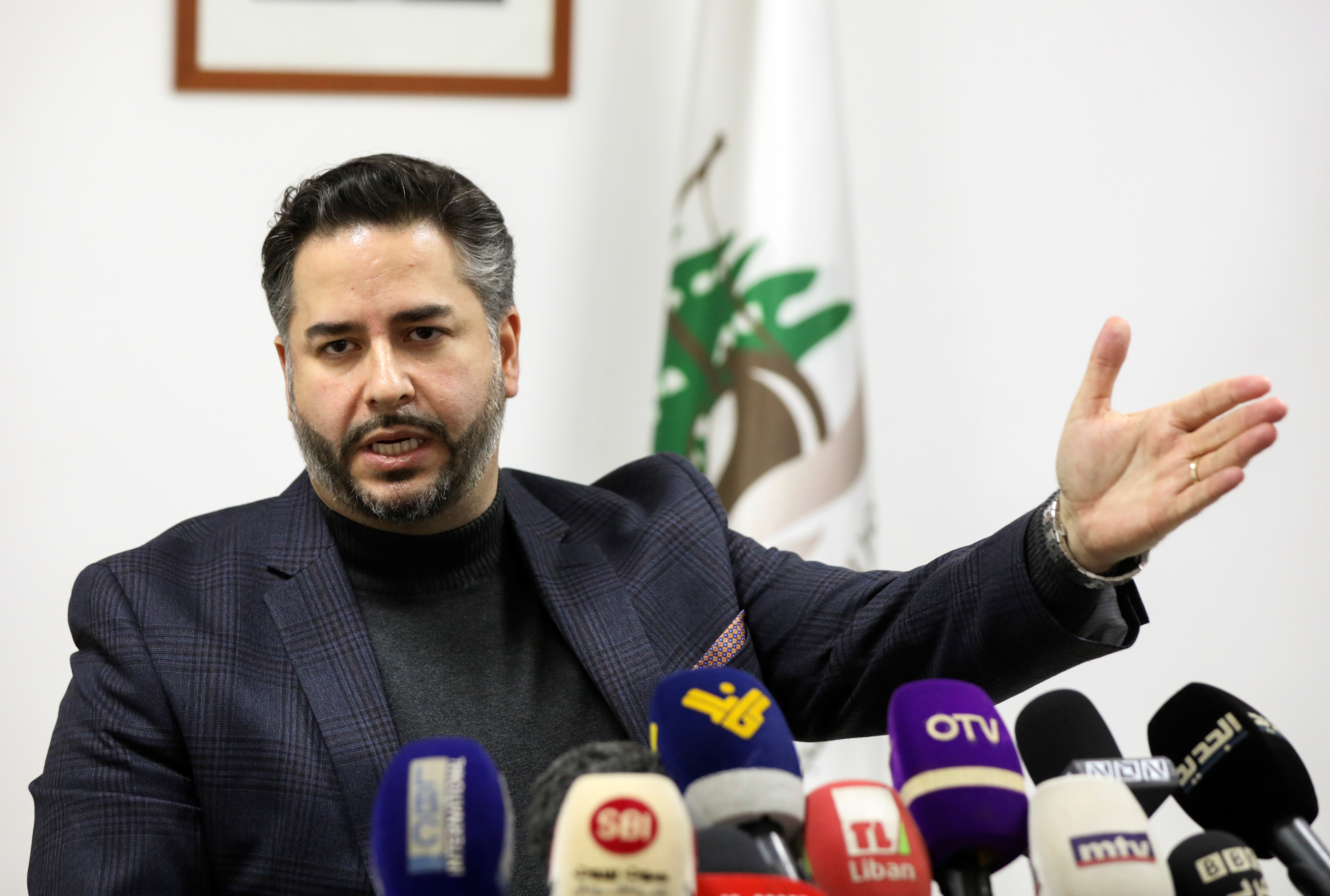 Lebanon's Economy Minister Amin Salam gestures as he speaks during a news conference in Beirut