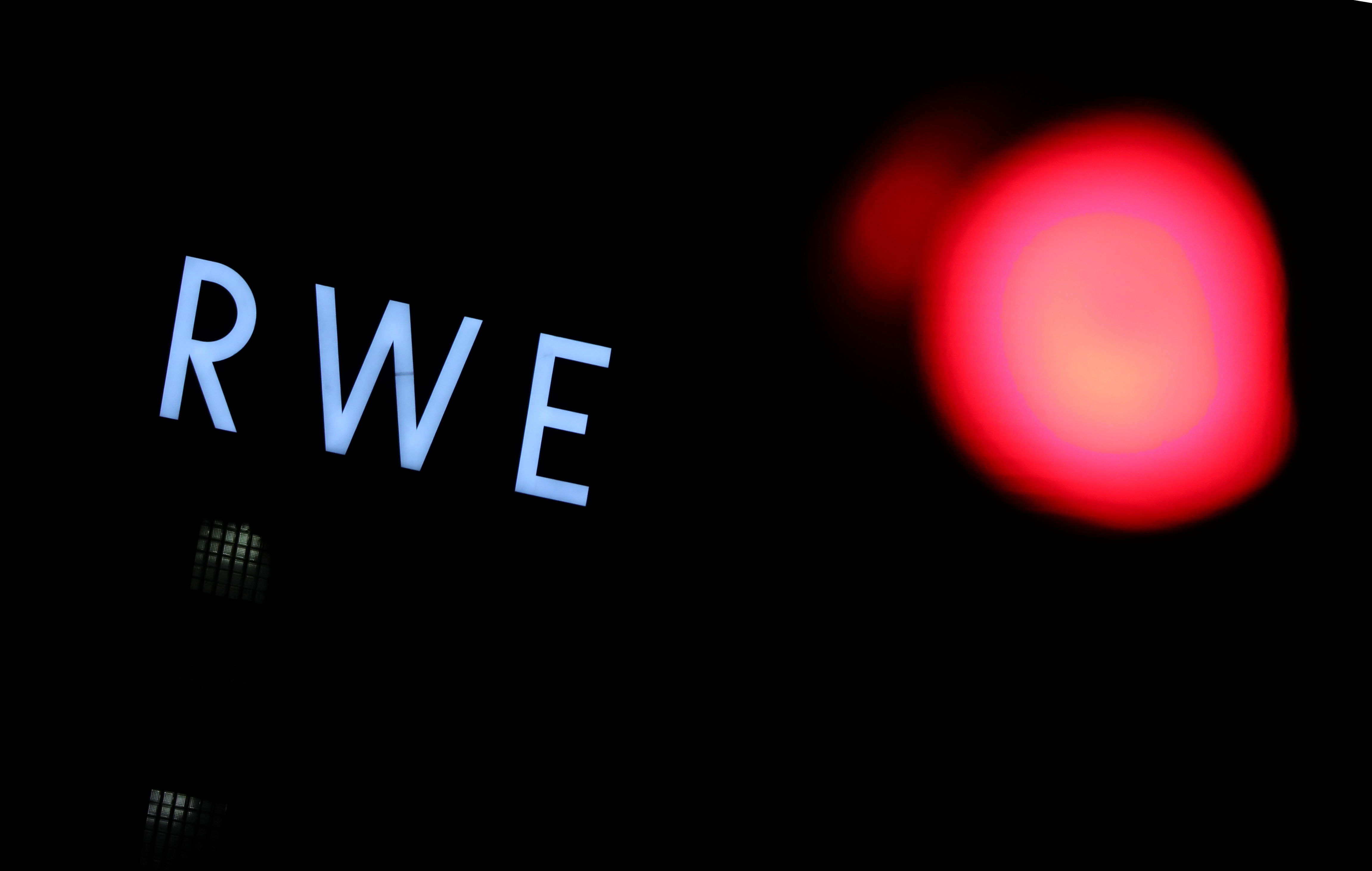 The logo of German utility and energy supplier RWE is pictured next to a traffic light outside RWE's lignite power plant in Weisweiler near the western German city of Aachen