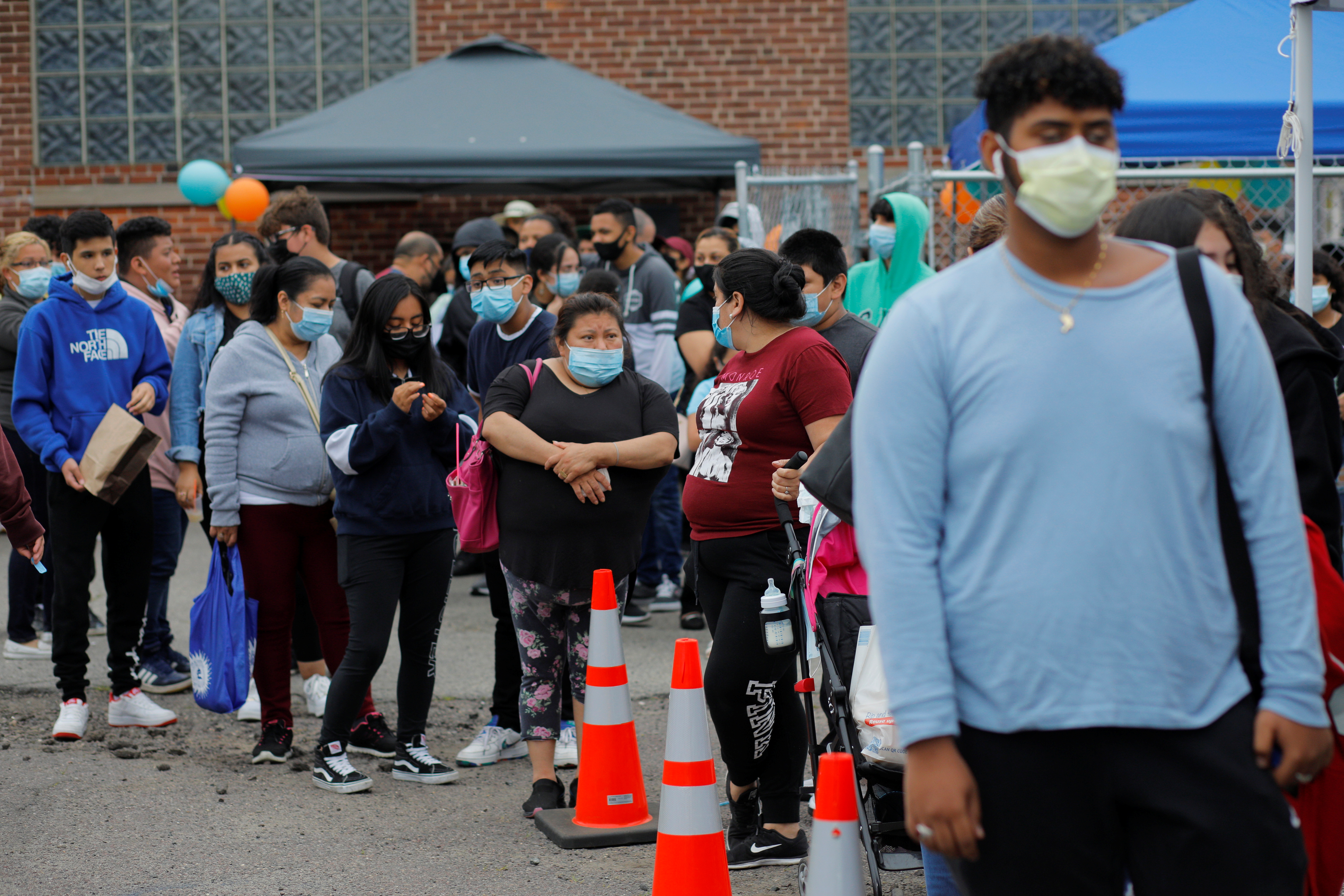 Residents line up for a COVID-19 vaccine clinic in Chelsea