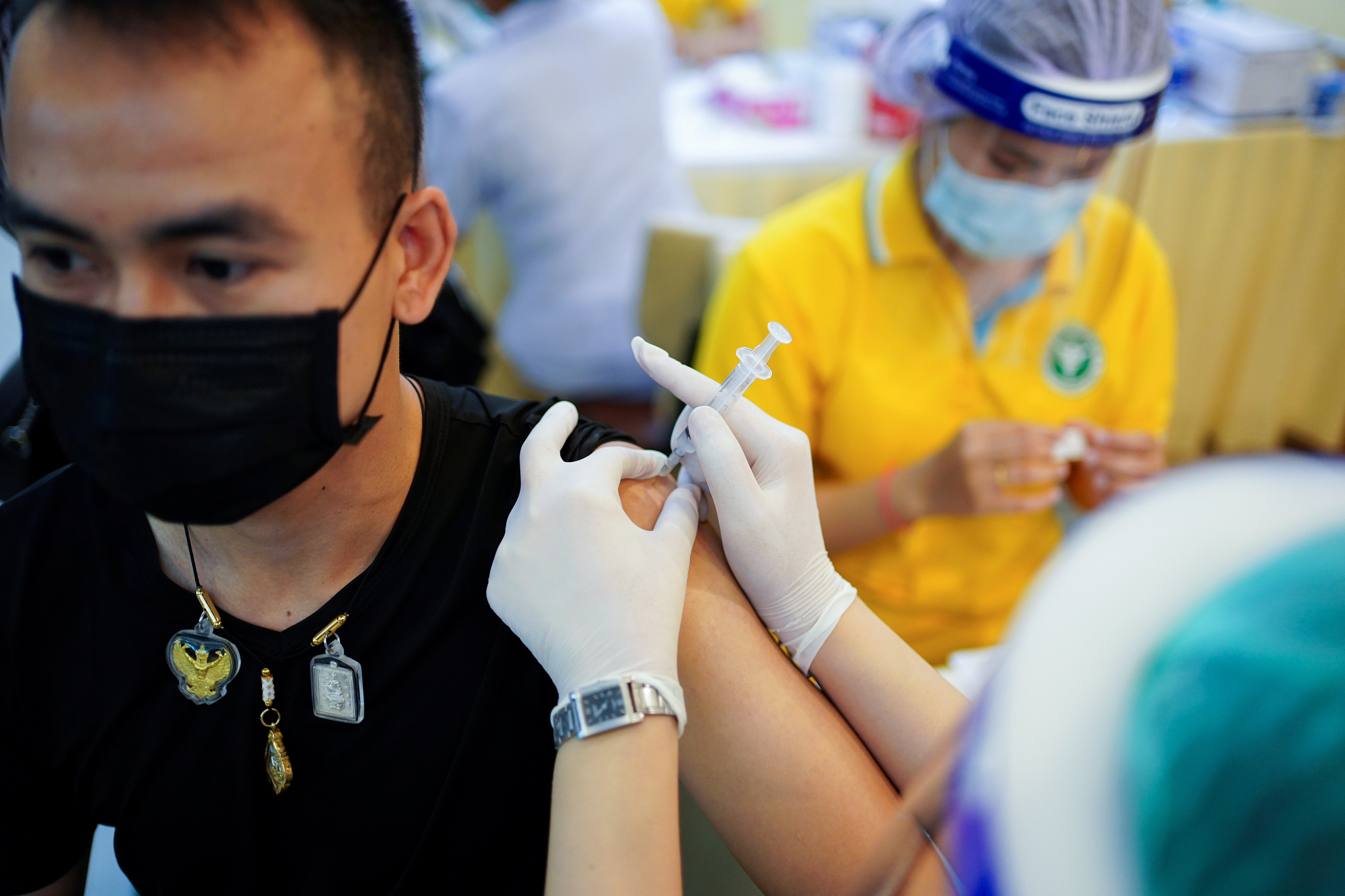 A man receives the Sinovac coronavirus disease (COVID-19) vaccine at the Samut Sakhon hospital in Samut Sakhon province