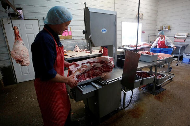 Mobile butcher Gerrit vande Bruinhorst works on a beef carcass in Picture Butte