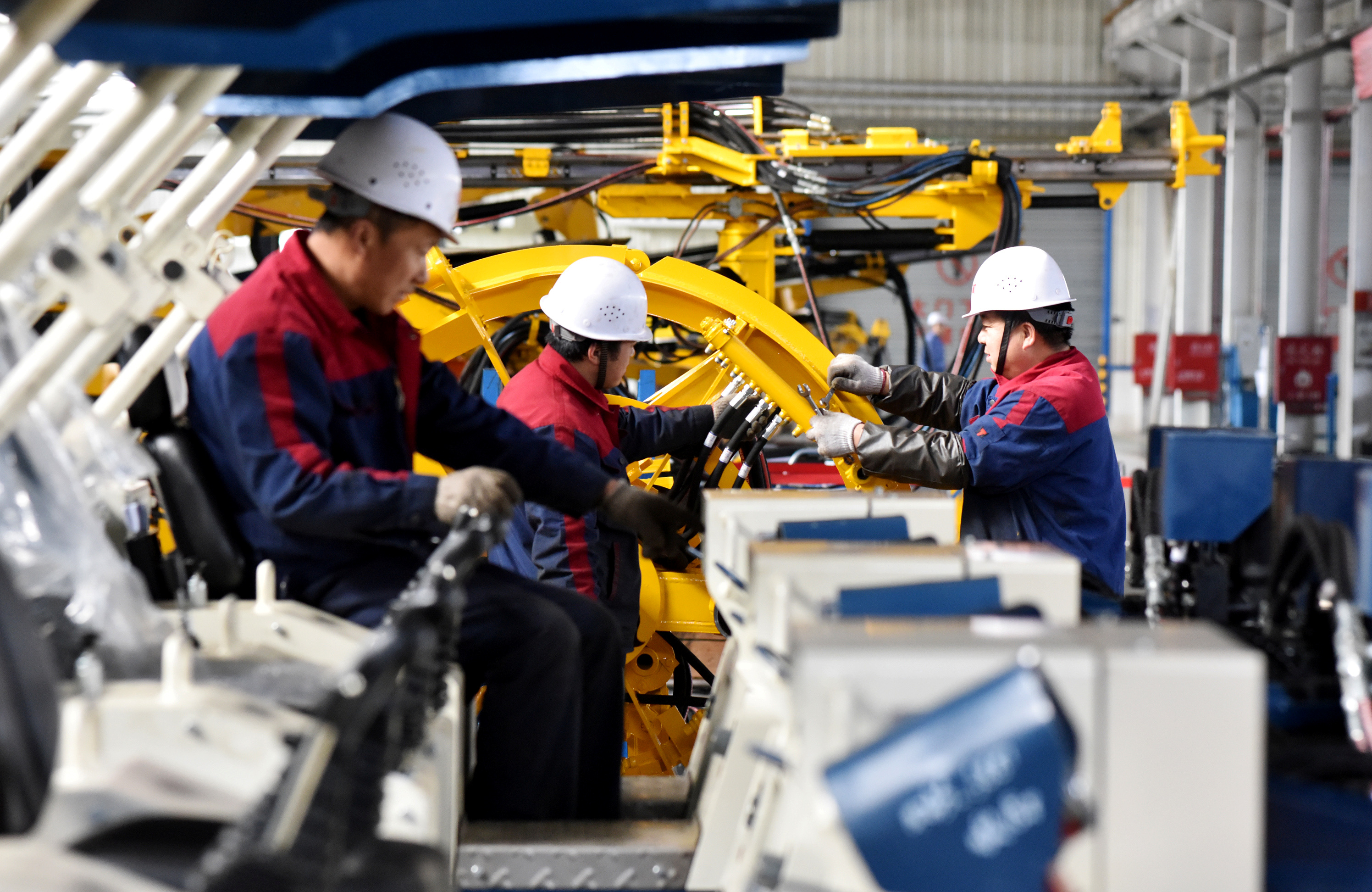 Employees work on a drilling machine production line at a factory in Zhangjiakou