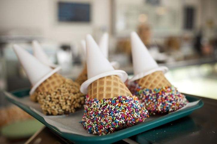 Chocolate-dipped, sprinkle-covered ice cream cones are seen at Sundaes and Cones ice cream shop in New York