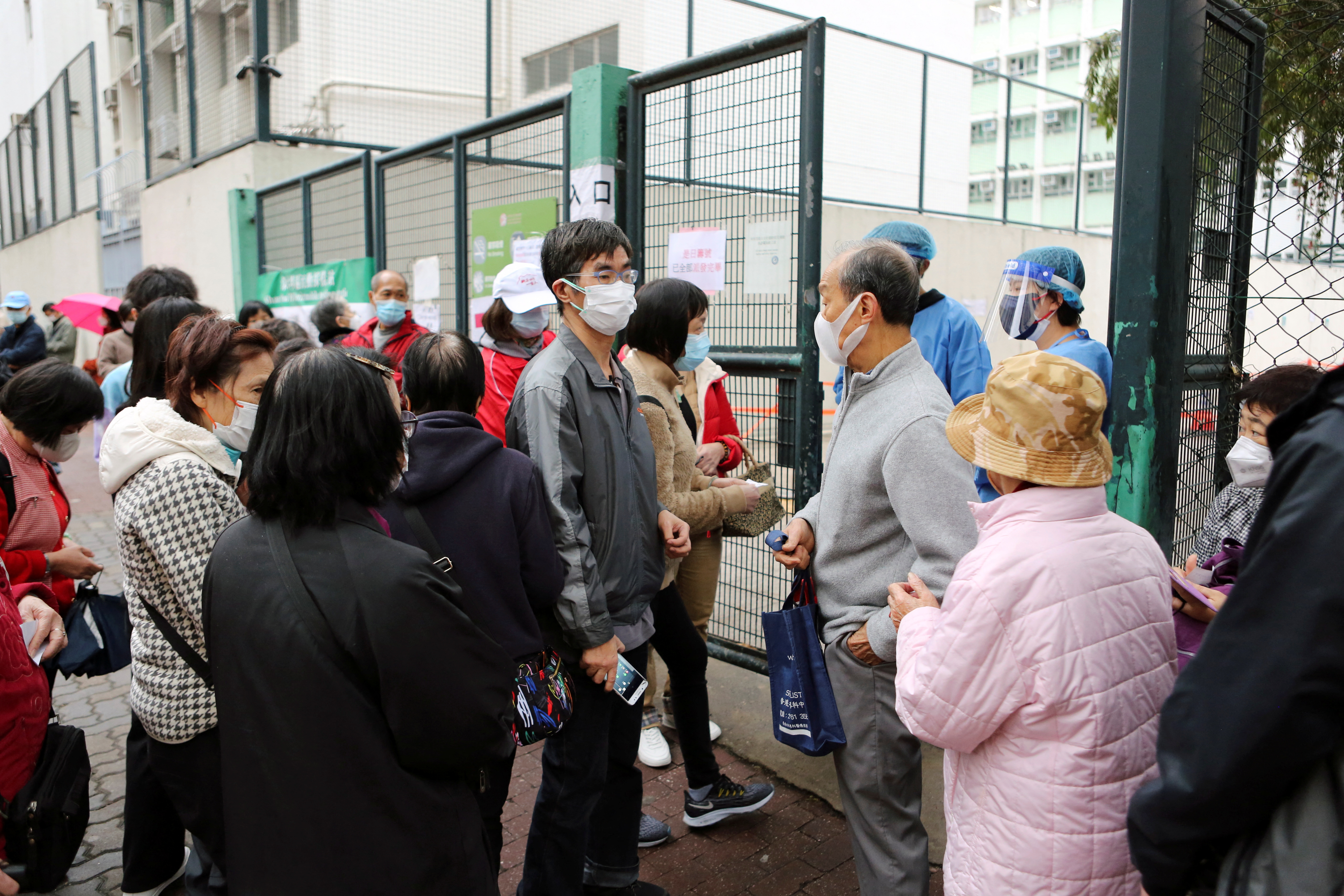 Lo Kai-wai queues outside a testing station for COVID-19 in Hong Kong