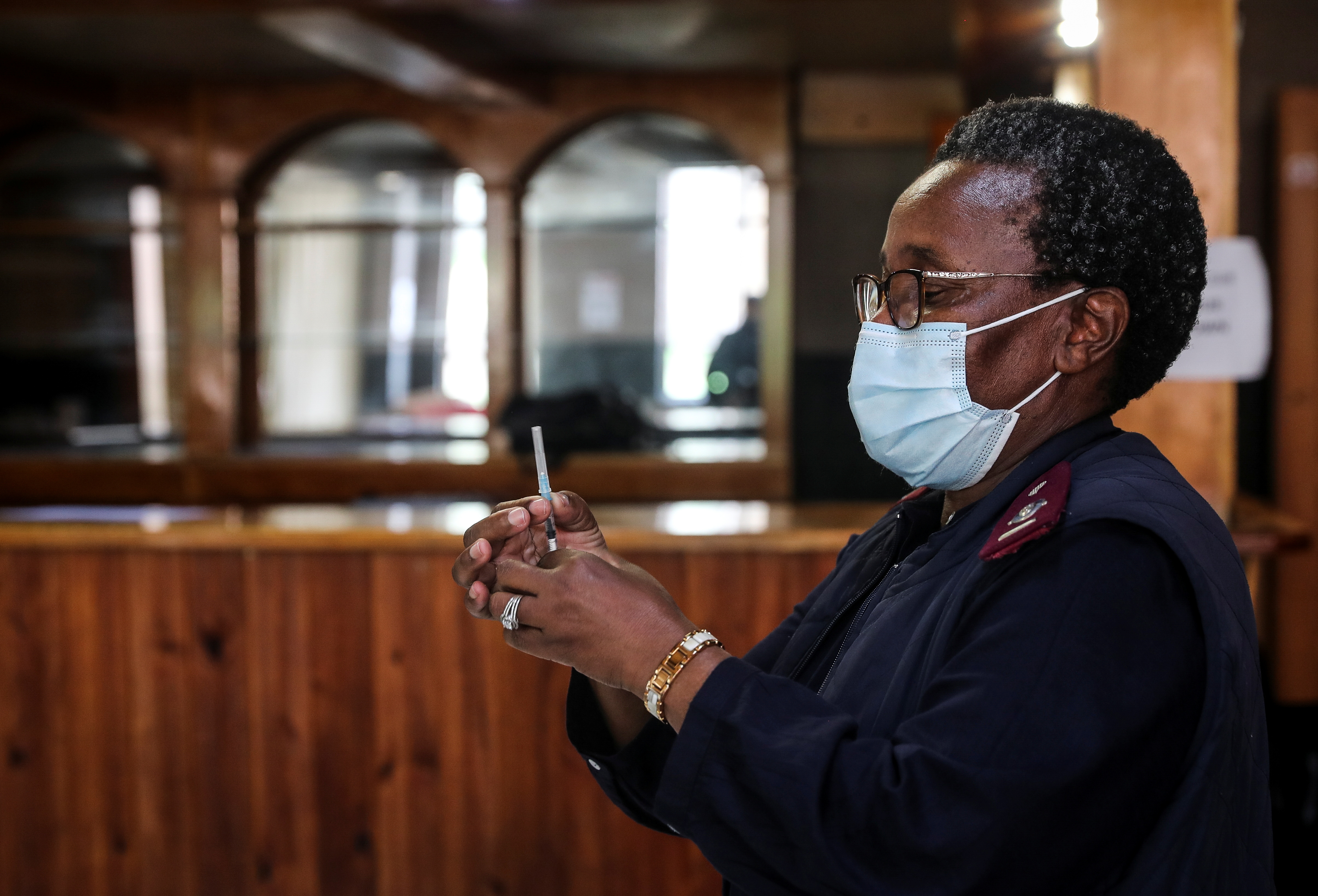 A healthcare worker prepares a dose of the Pfizer coronavirus disease (COVID-19) vaccine, amidst the spread of the SARS-CoV-2 variant Omicron, in Johannesburg