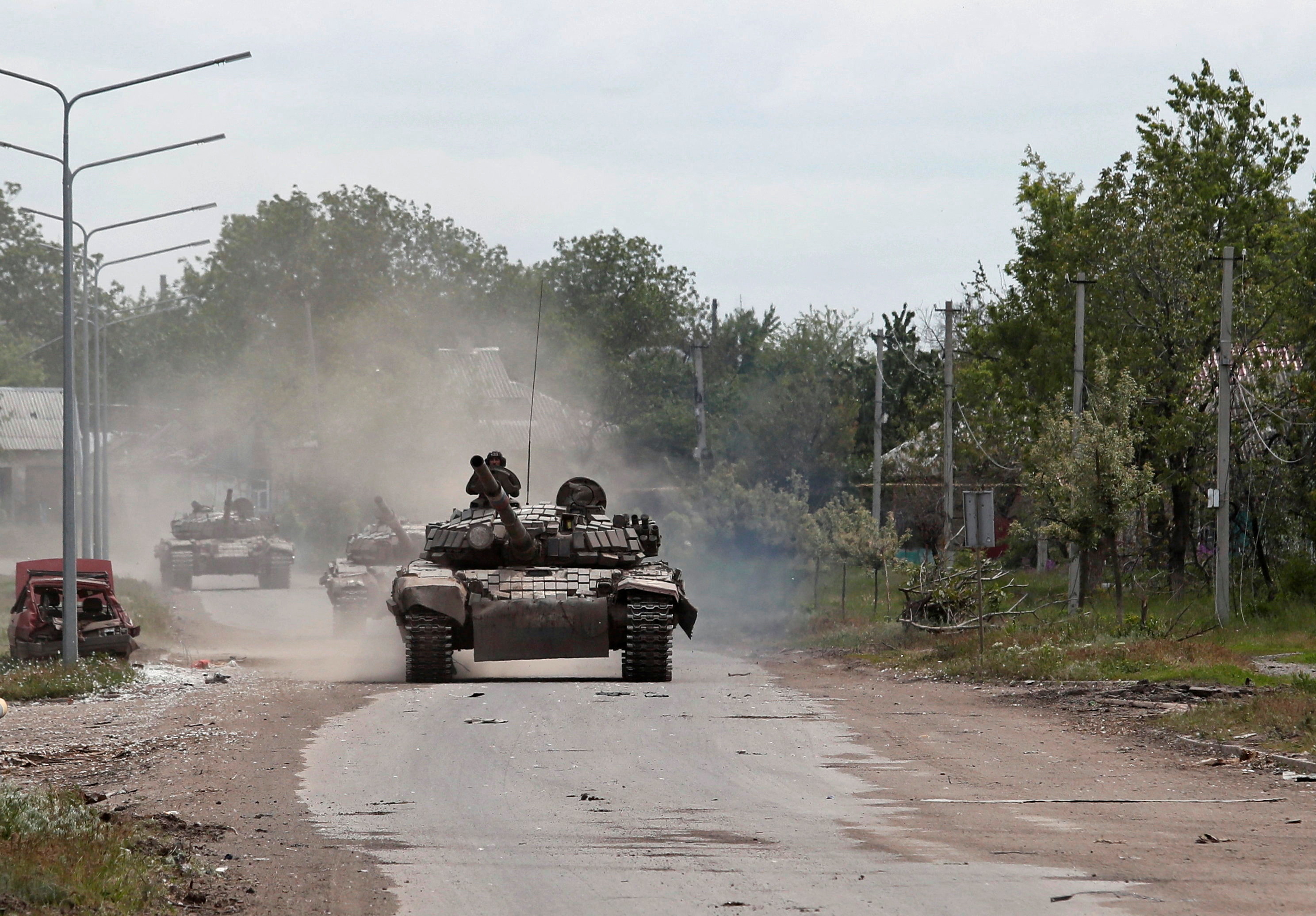 Tanks of pro-Russian troops drive along a street in Popasna