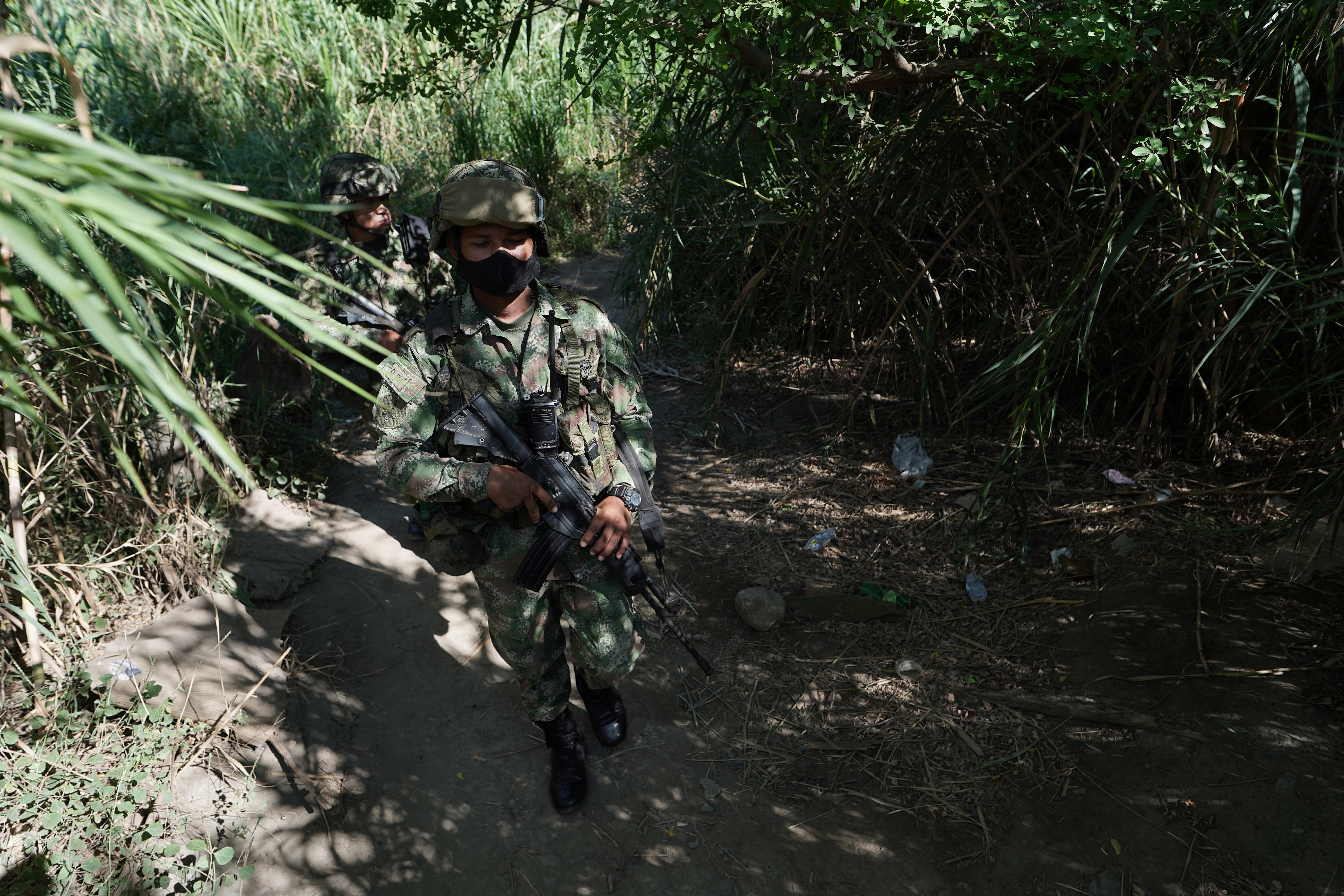 Members of the Colombian military patrol between Colombia and Venezuela by an unofficial crossing, as Venezuela reopens its borders with Colombia after a nearly three-year closure due to political tensions, in Cucuta, Colombia October 7, 2021.  REUTERS/Nathalia Angarita