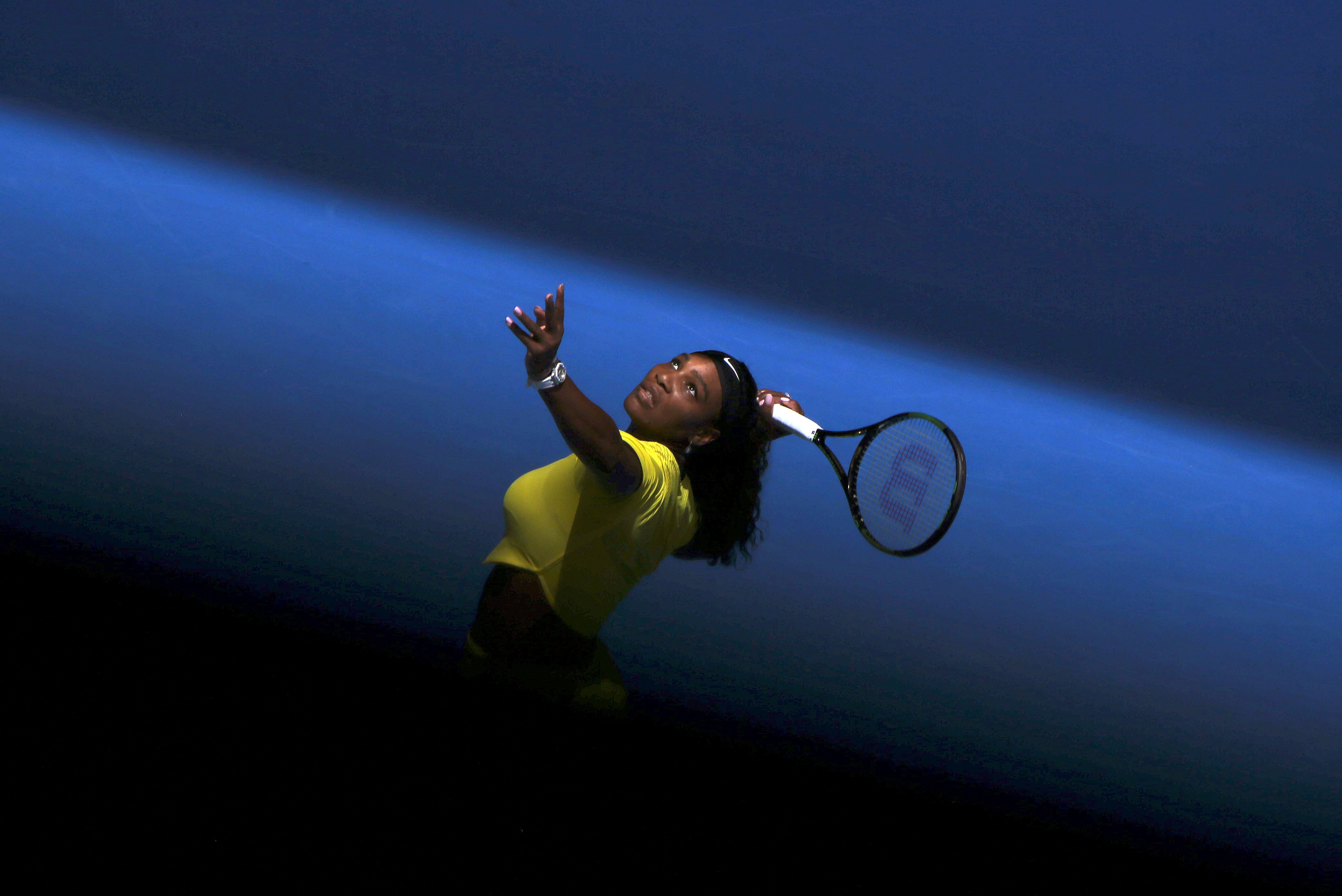 Williams of the U.S. serves during her first round match against Italy's Giorgi at the Australian Open tennis tournament at Melbourne Park, Australia