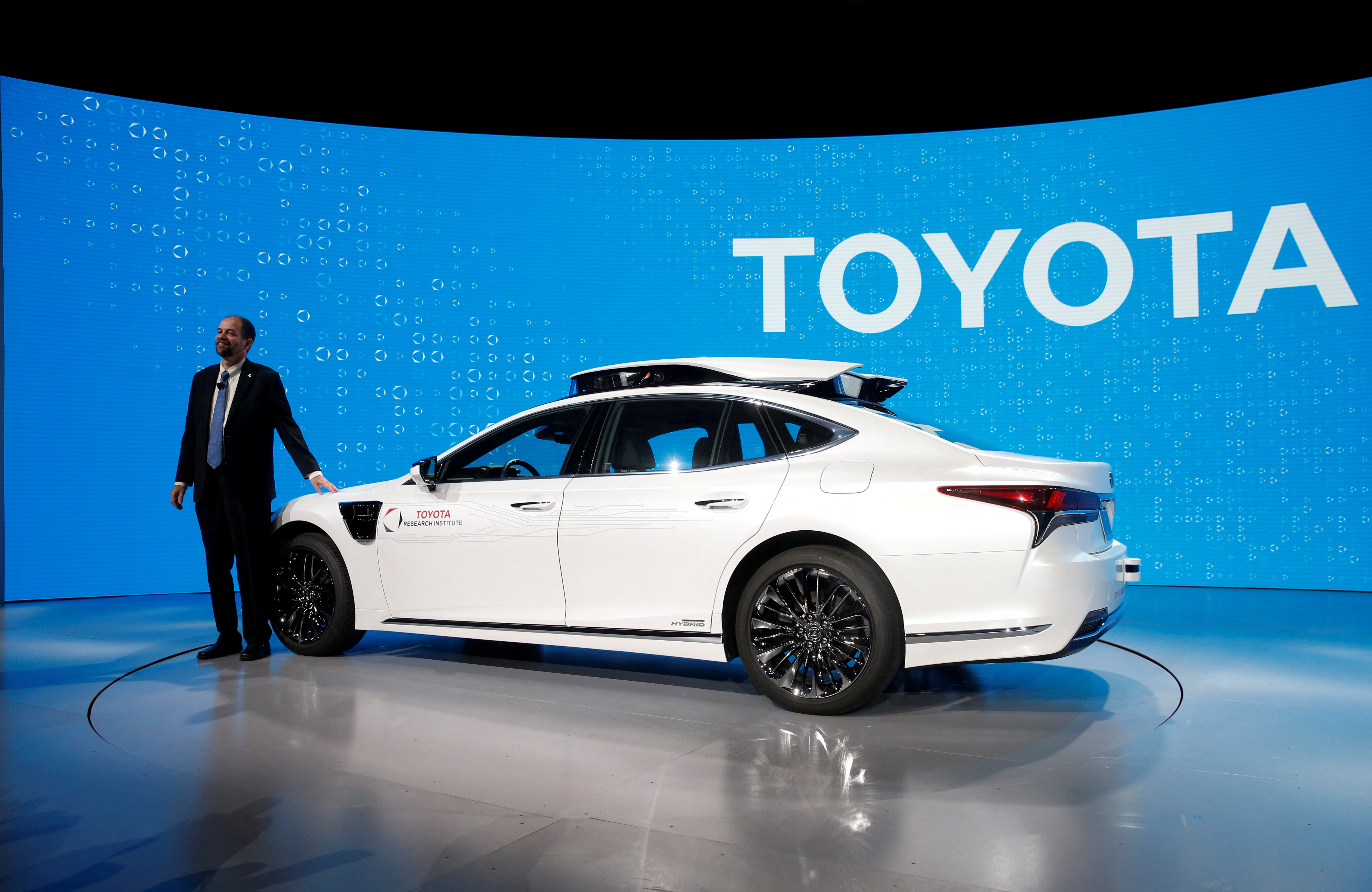 Gill Pratt, CEO of the Toyota Research Institute (TRI), poses by a research vehicle equipped with Toyota Guardian, a accident avoidance system that assists drivers, during a Toyota news conference at the 2019 CES in Las Vegas,