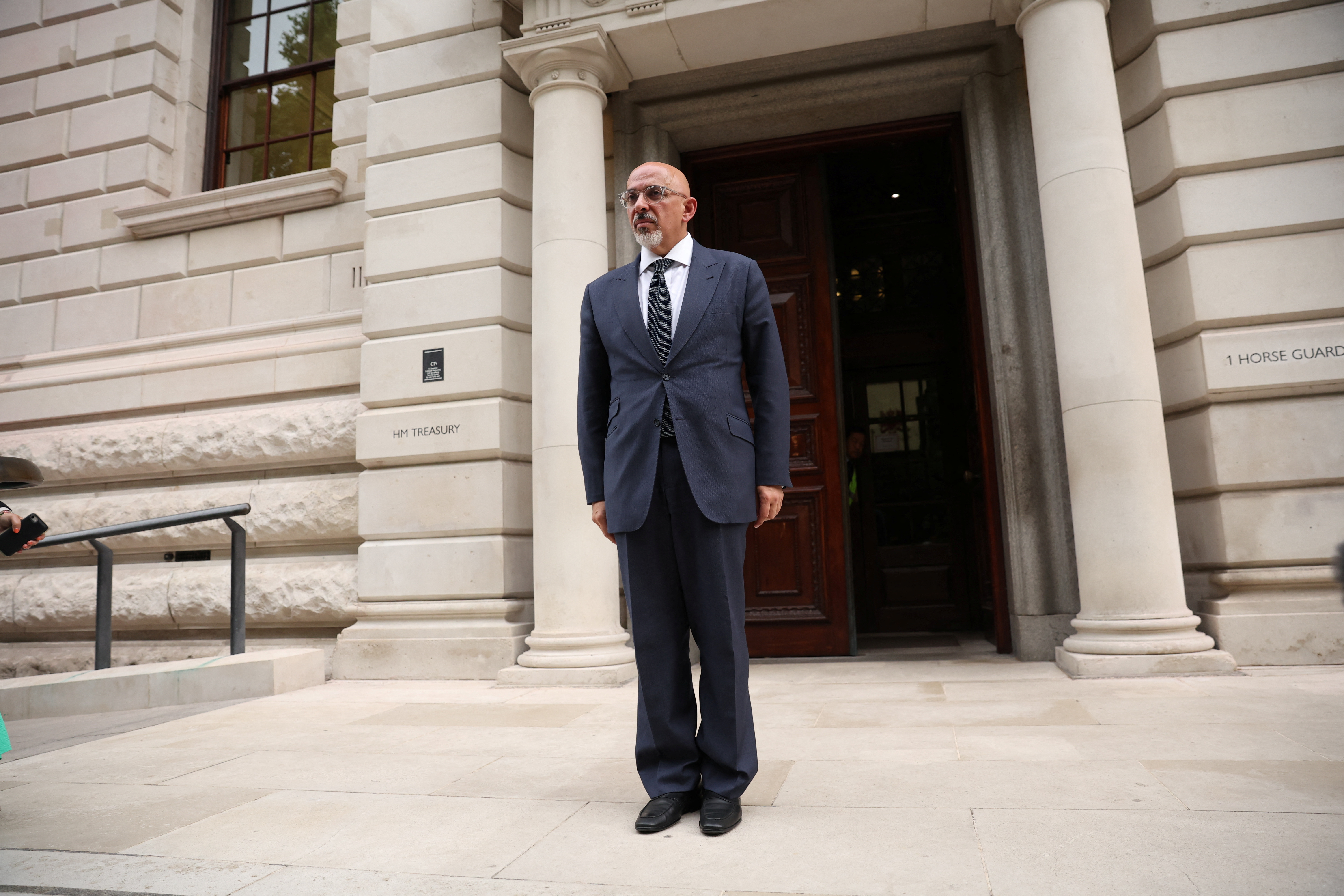 British new Chancellor of the Exchequer Nadhim Zahawi stands near Treasury building, in London