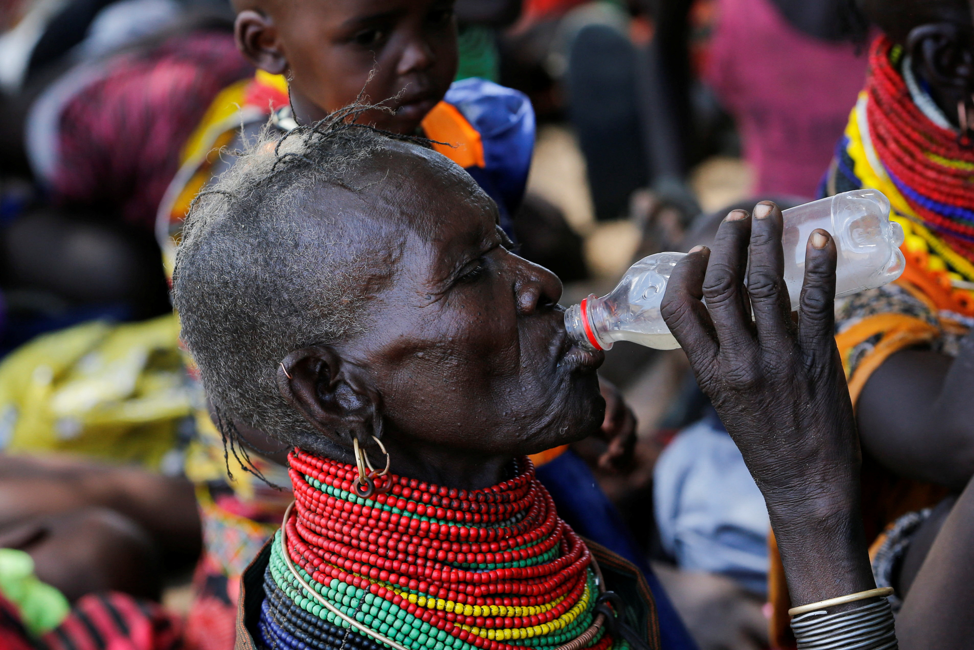 A woman from the Turkana pastoralist community affected by the worsening drought due to failed rain seasons, drinks water as she attends an integrated outreach medical clinic in Kakimat village in Turkana