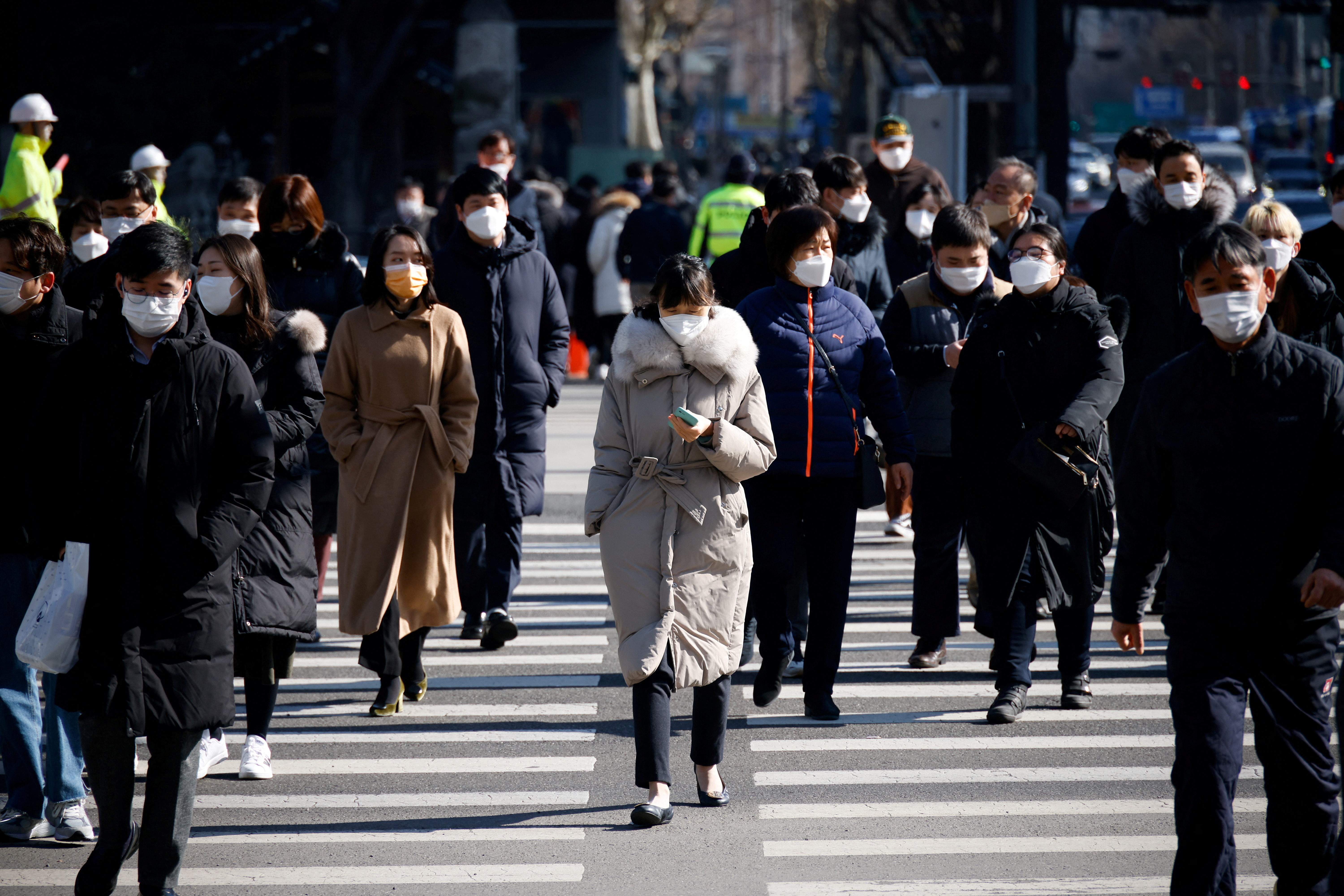 Commuters cross a zebra crossing, amid the coronavirus disease (COVID-19) pandemic in Seoul