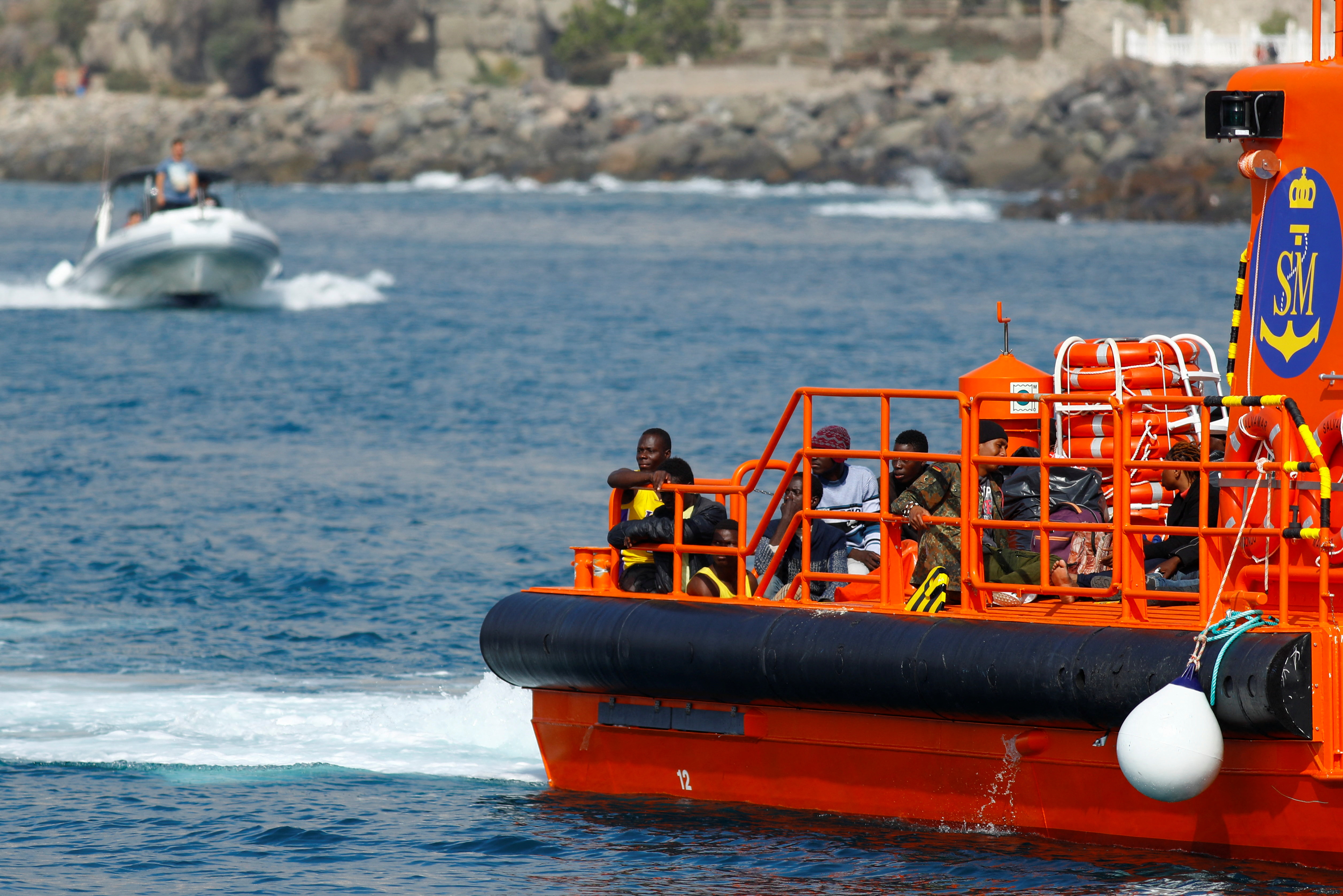 Migrants wait to disembark from a Spanish coast guard vessel, in the port of Arguineguin, in the island of Gran Canaria, Spain, November 23, 2021. REUTERS/Borja Suarez