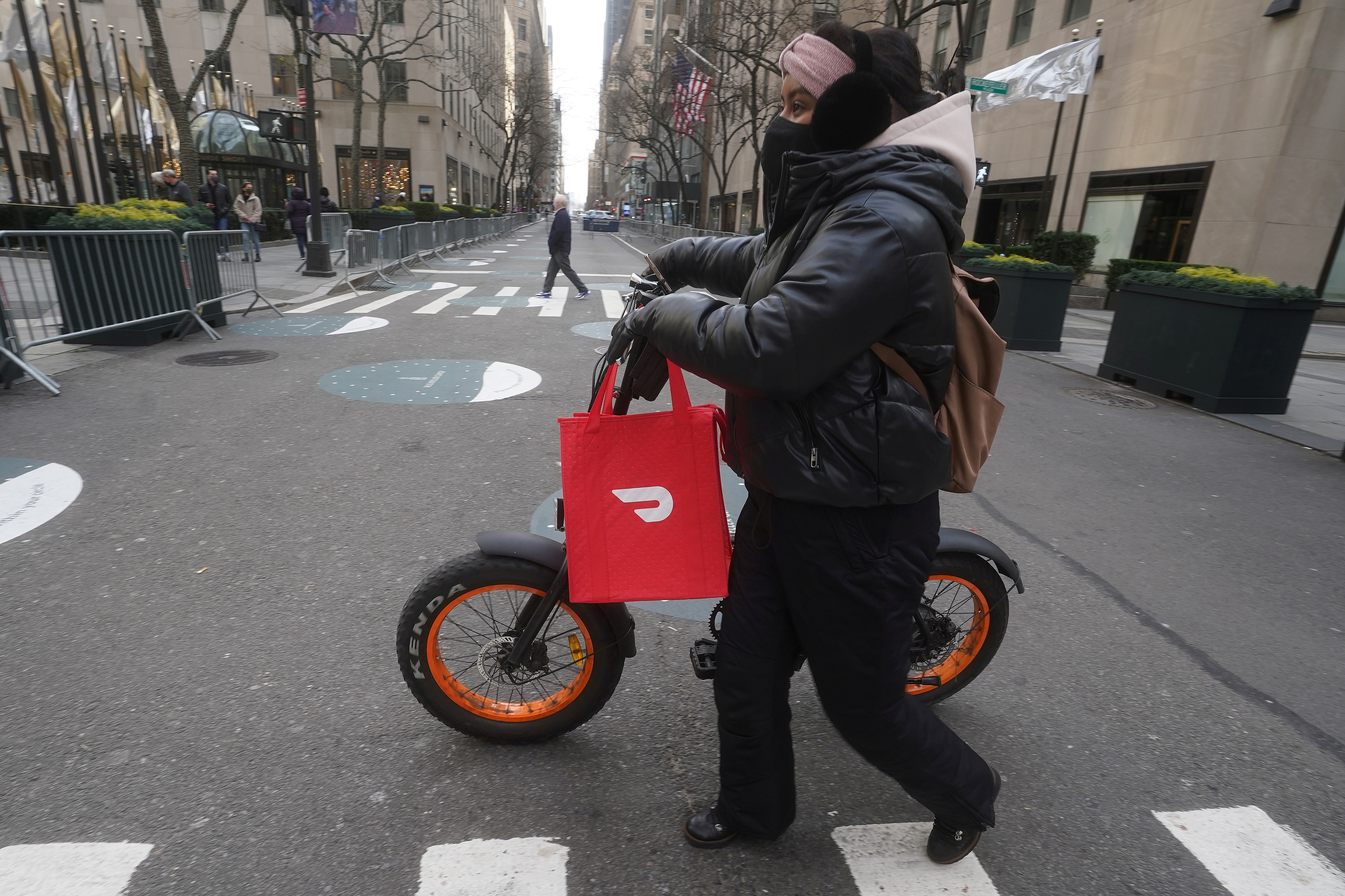 A DoorDash delivery person is pictured on the day they hold their IPO