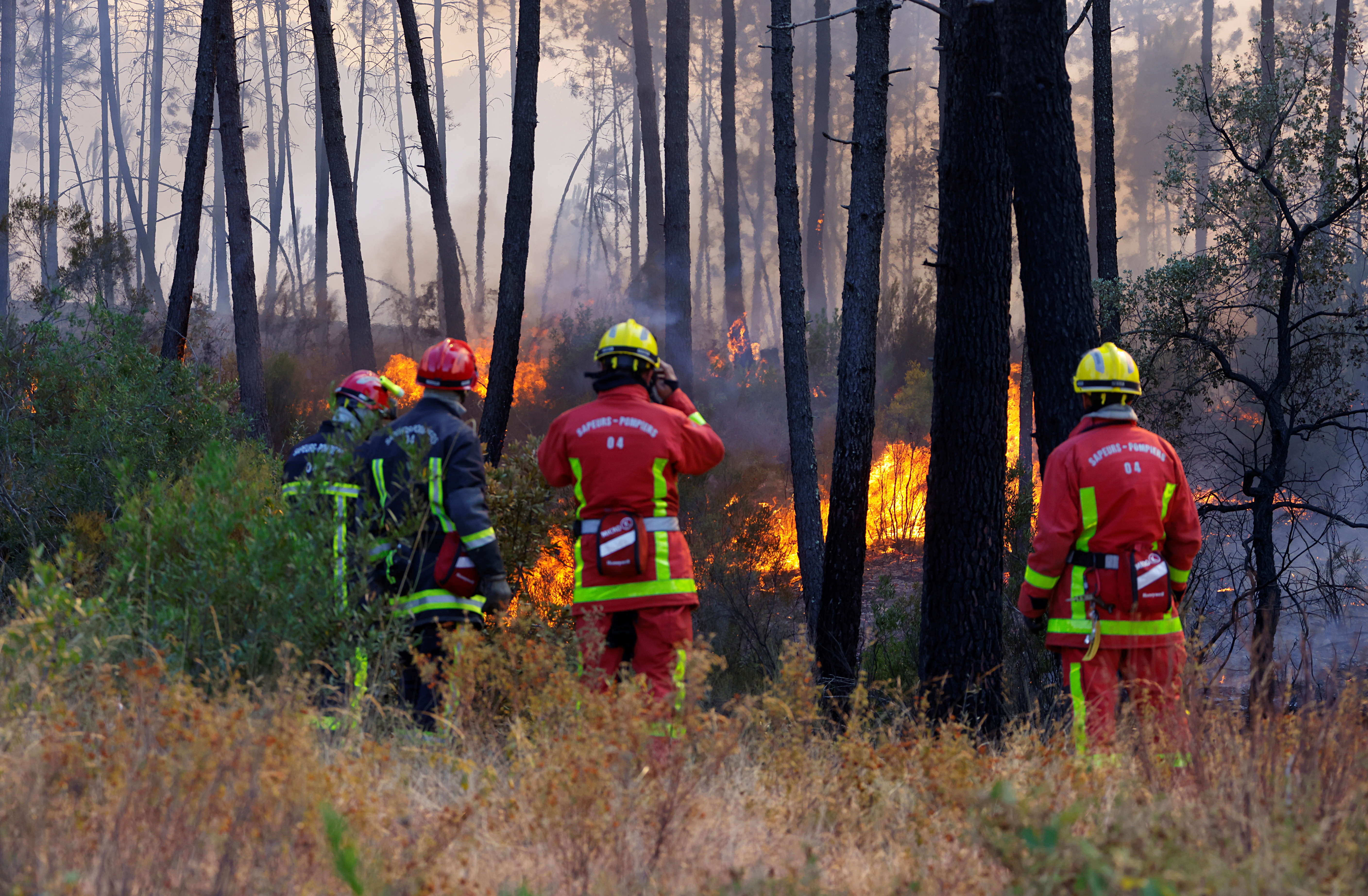 Firefighters work during a major wildfire that broke out in Vidauban, in the region of southern France, August 18, 2021. REUTERS/Eric Gaillard