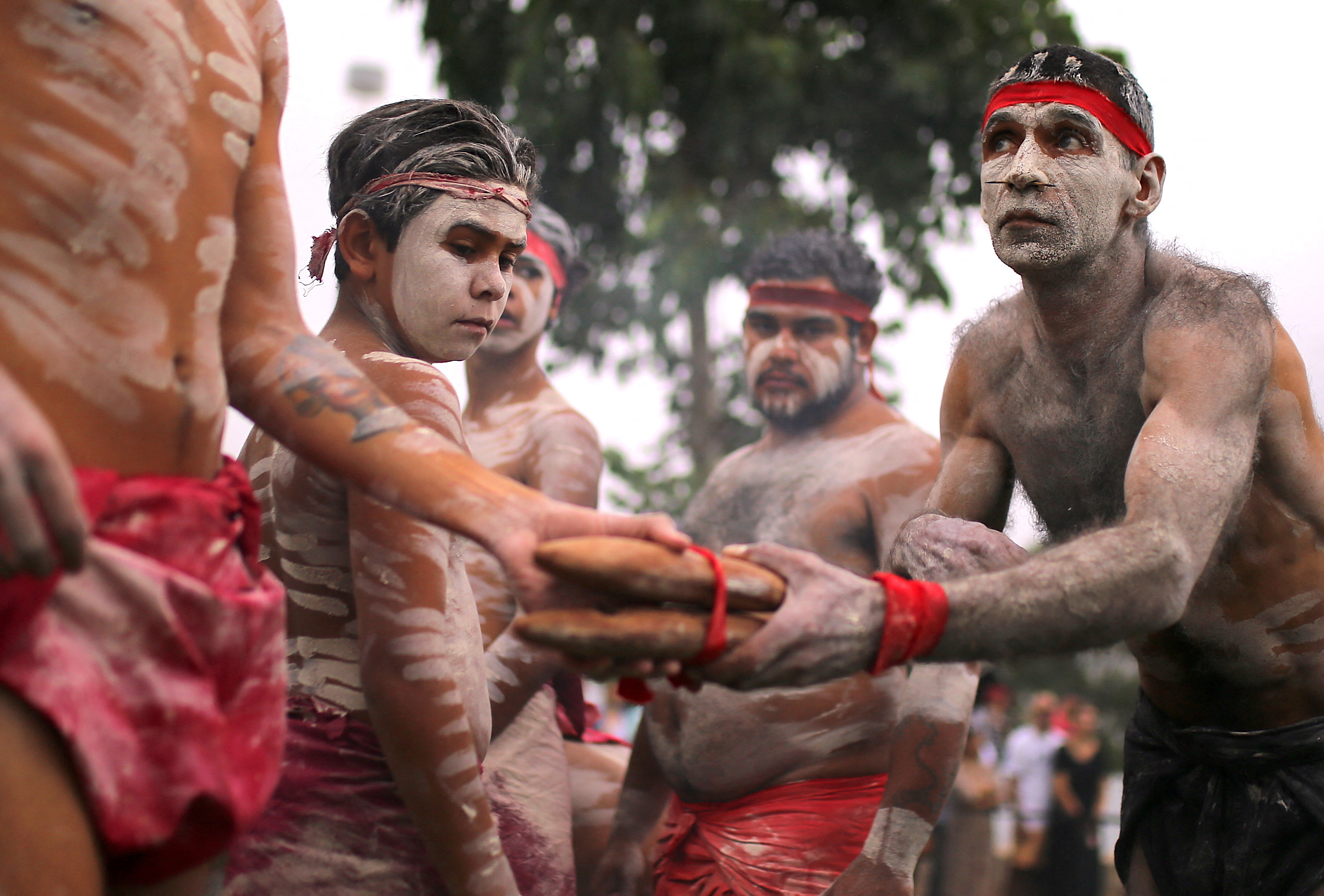 Members of Koomurri Aboriginal Dance Troupe participate in a traditional Australian Aboriginal smoking ceremony as part of celebrations for Australia Day, which marks the arrival of Britain's First Fleet in 1788, in central Sydney
