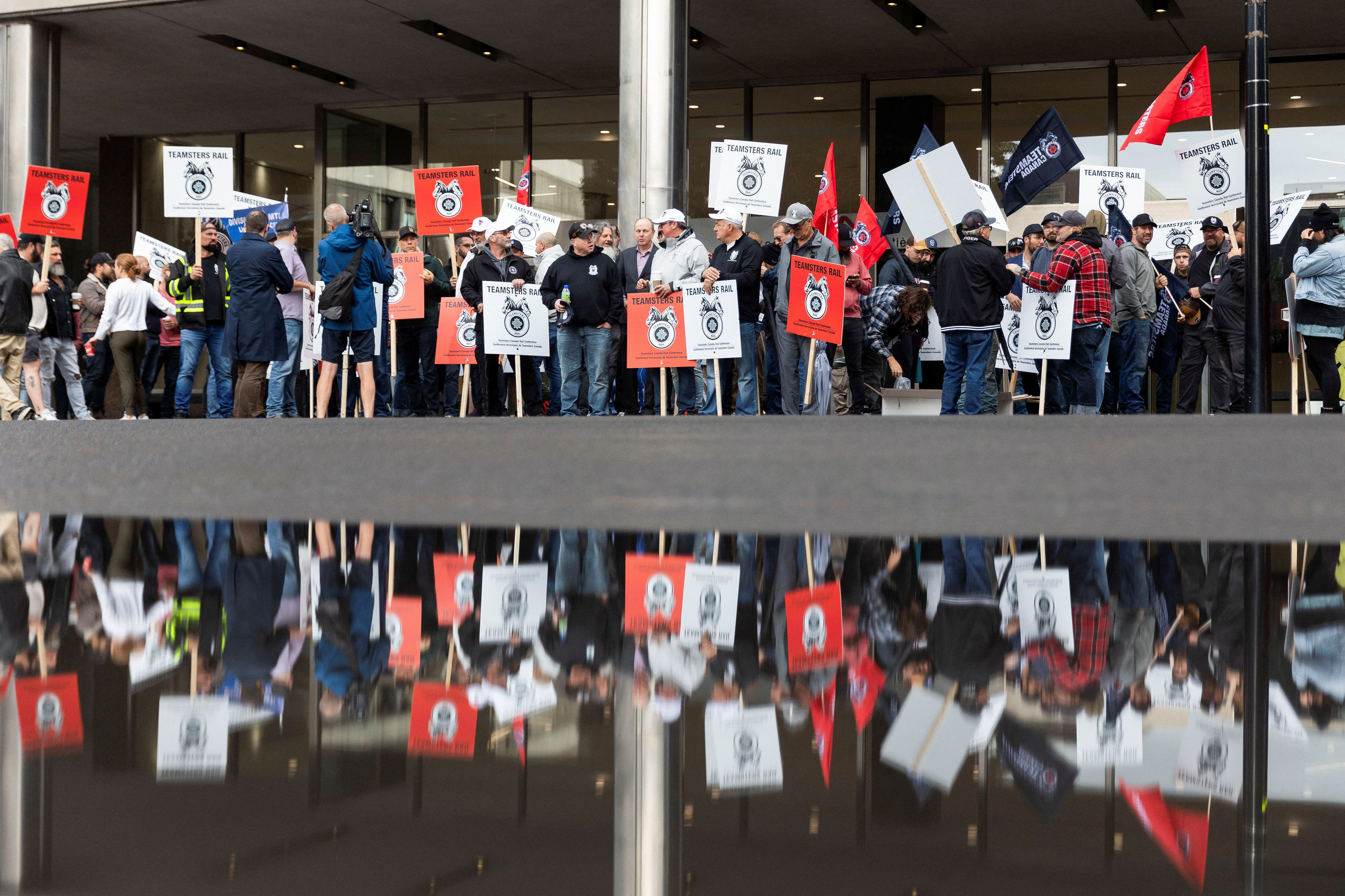 Striking Teamsters union workers picket CN railway HQ in Montreal